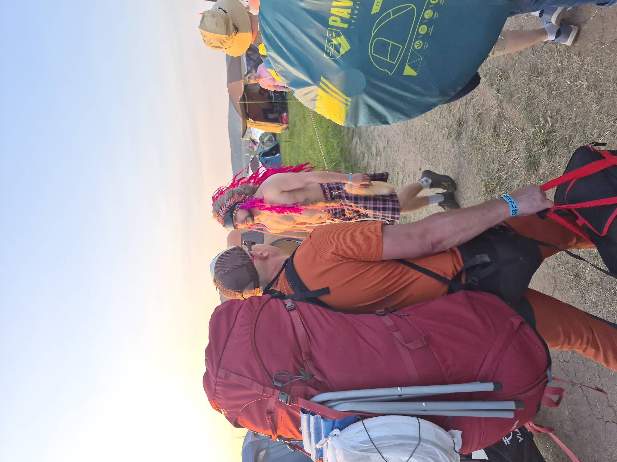 Costumed festival crowd camps out at sunset in Lagunovo