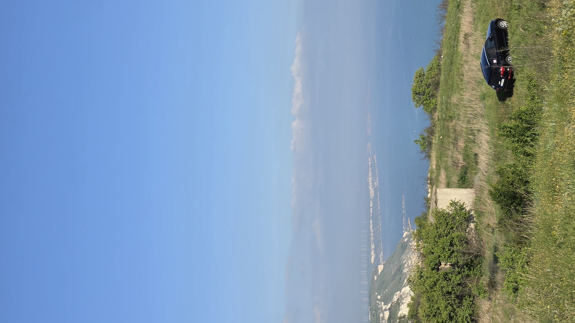 Black car parked on Bulgarian cliff overlooking Black Sea