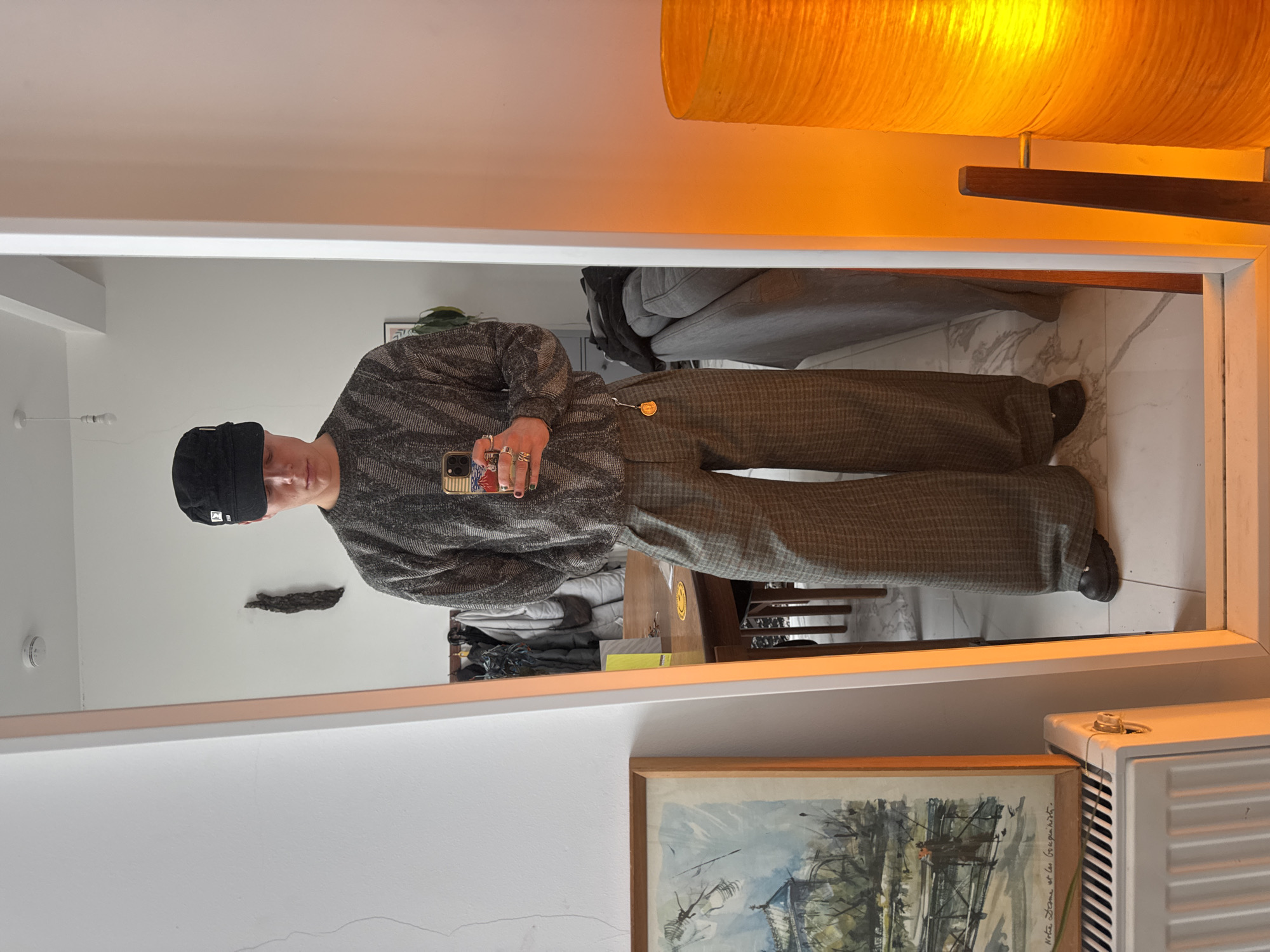 Person takes mirror selfie in London wearing Honda cap