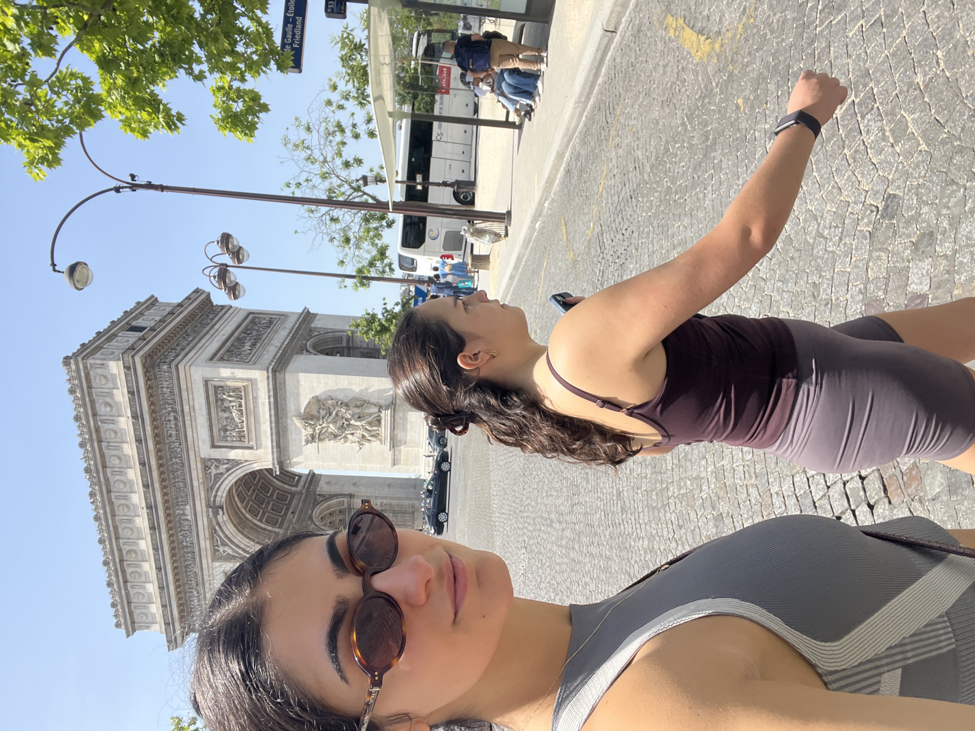 Tourists pose for photos at Arc de Triomphe
