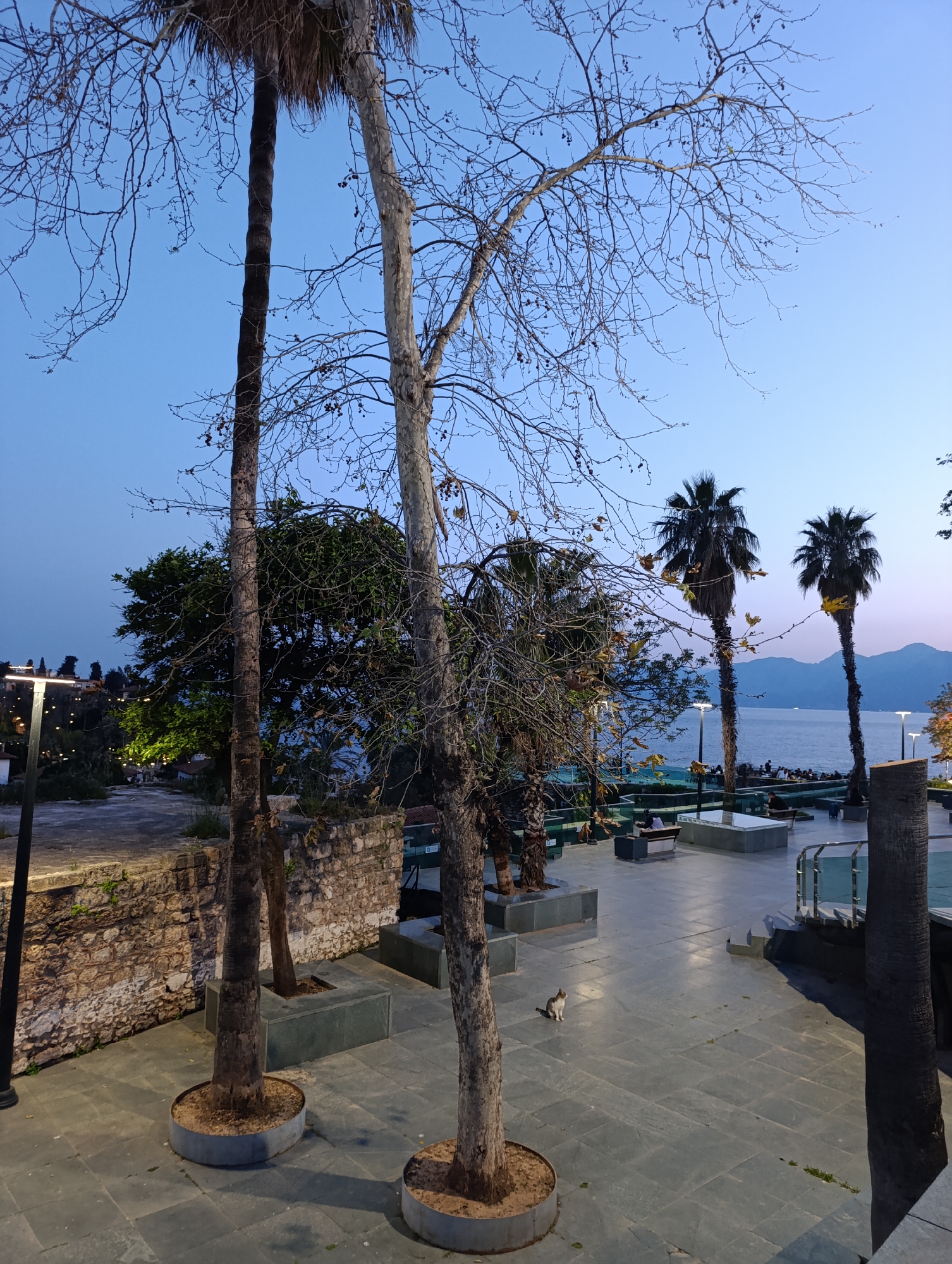Tourist documents evening stroll through historic Antalya district