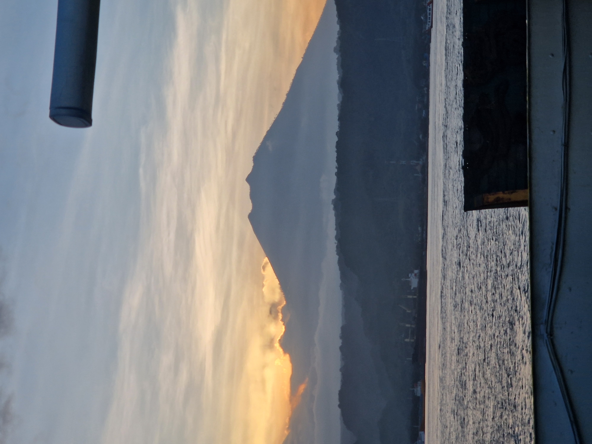 Ferry passengers witness sunset mountain views near Ketapang, Indonesia