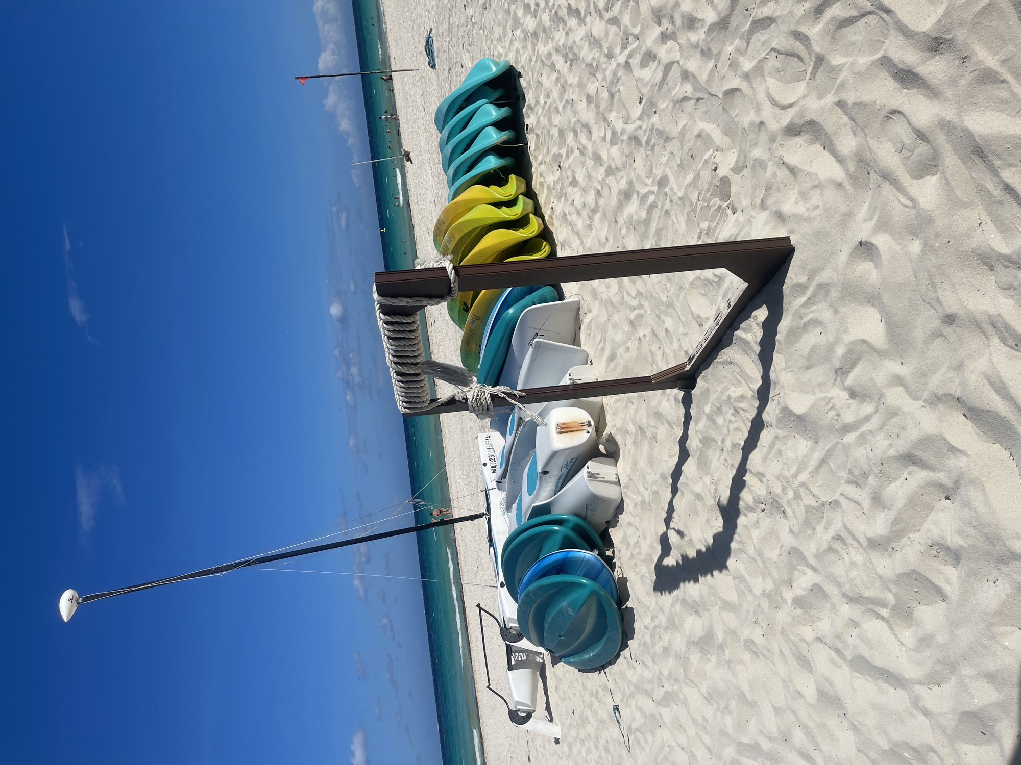 Kayaks stacked on sunny Playa del Carmen beach
