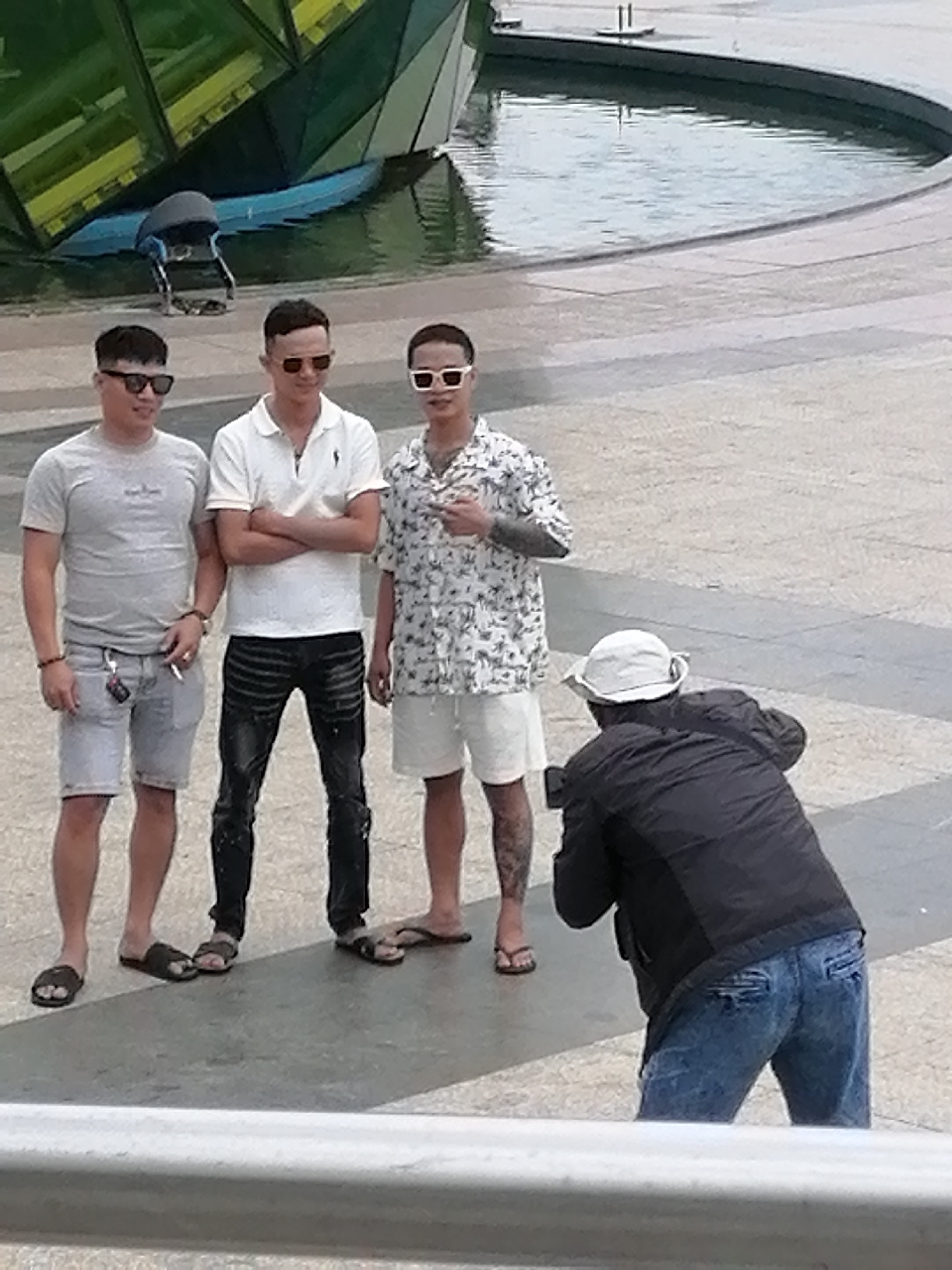 Group moment at a Da Lat public square near a water feature