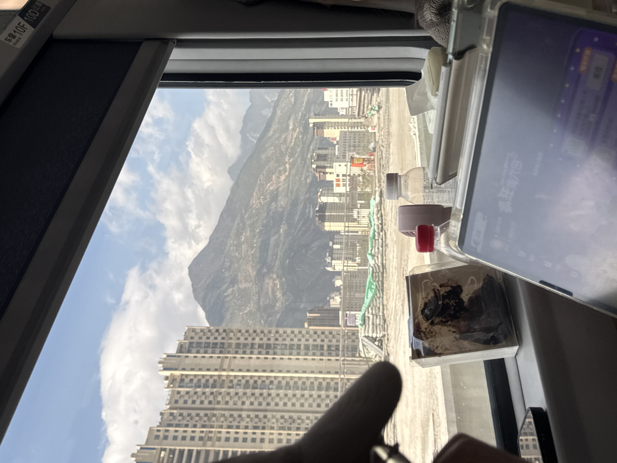 Train passenger captures window view while traveling through Longnan