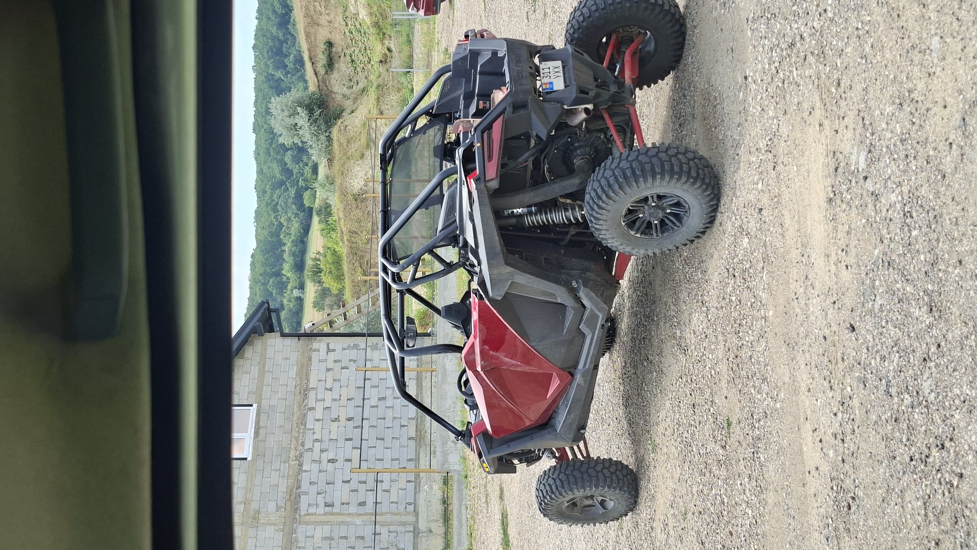 Polaris RZR parked on gravel near a construction site in Moldova