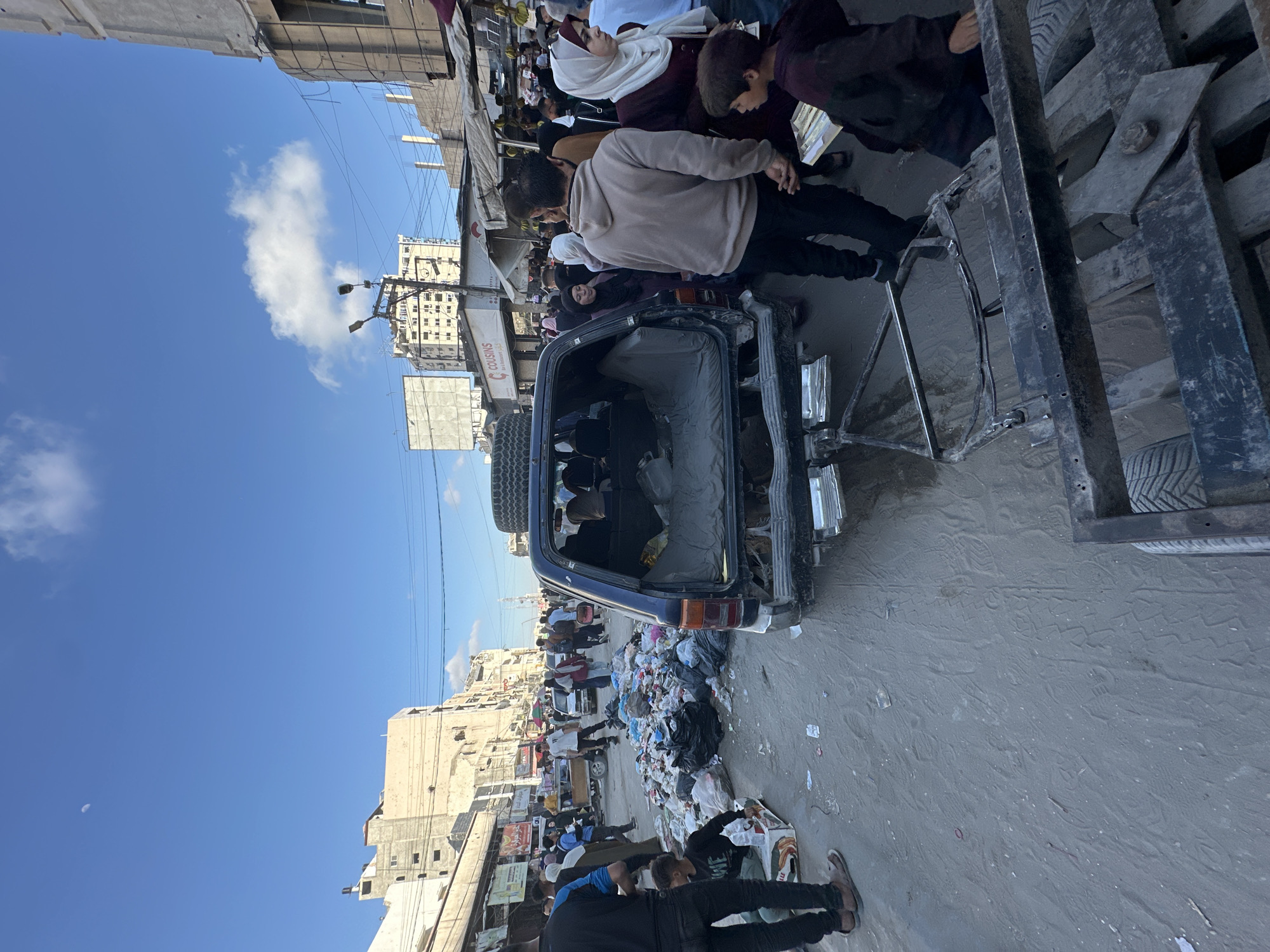 Gaza street markets bustling despite urban damage, families sheltering
