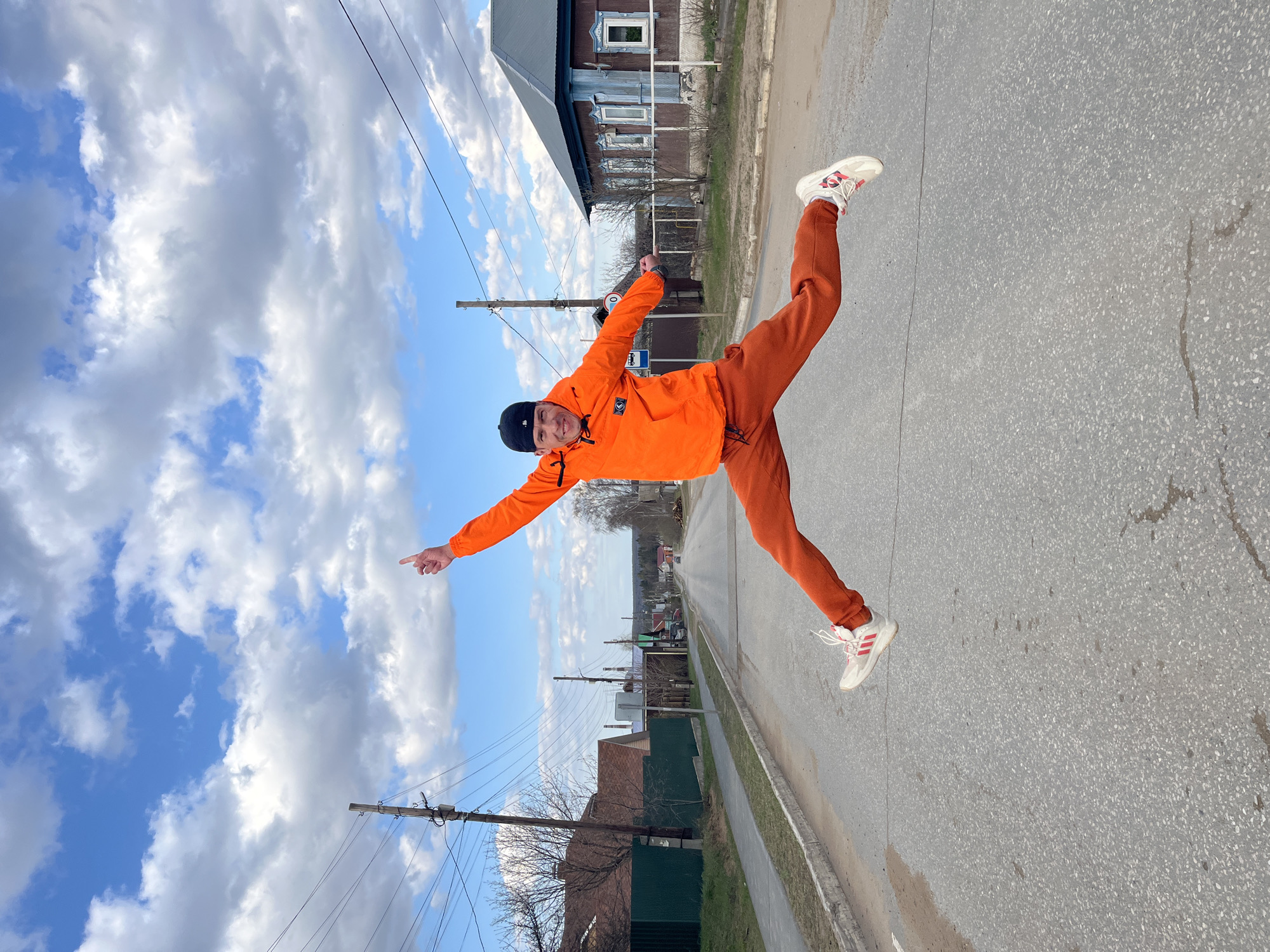 Young man performs dynamic poses during outdoor photoshoot in Chaikovsky