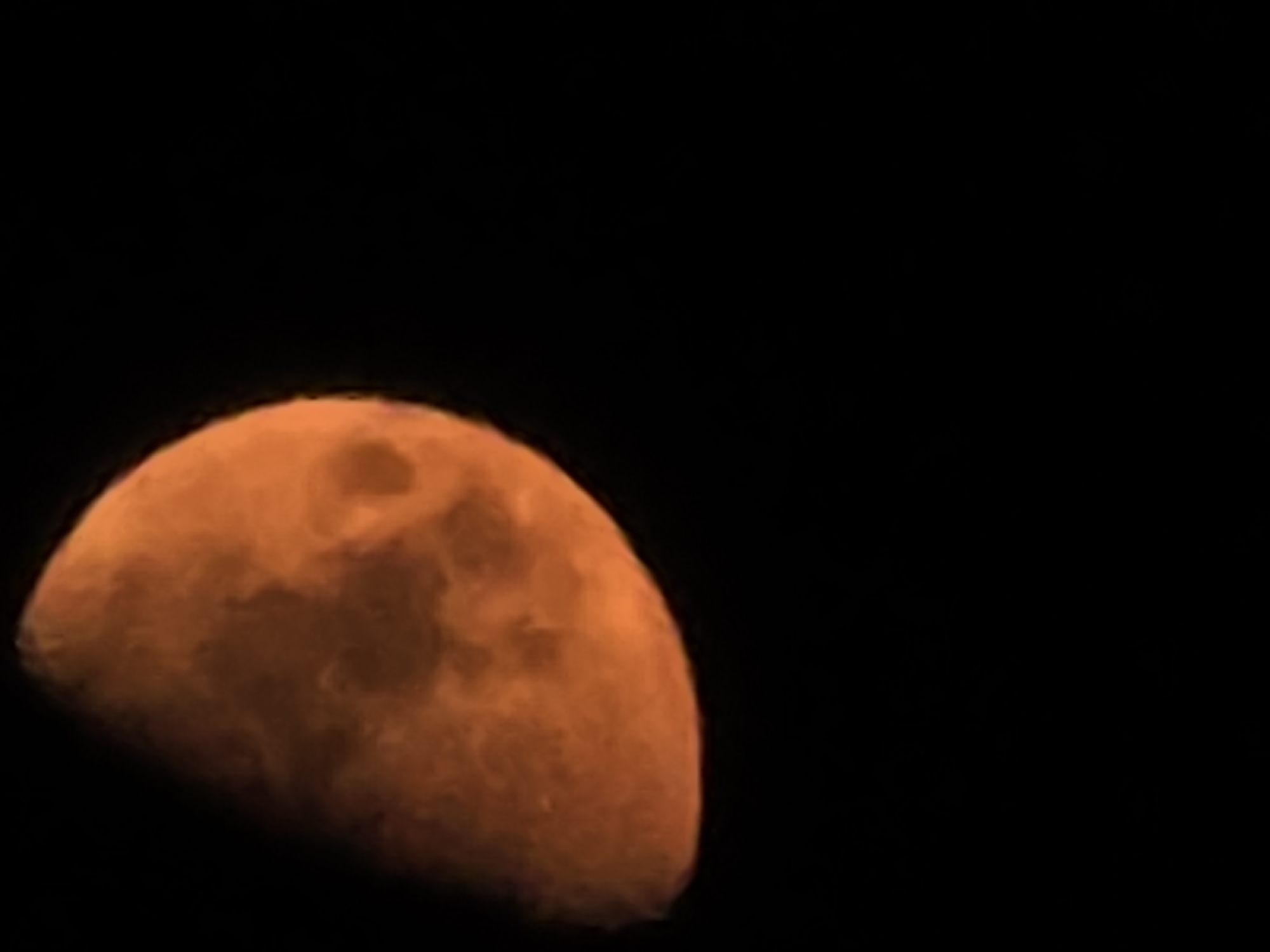 Orange moon photographed up close over Yambol on a July night