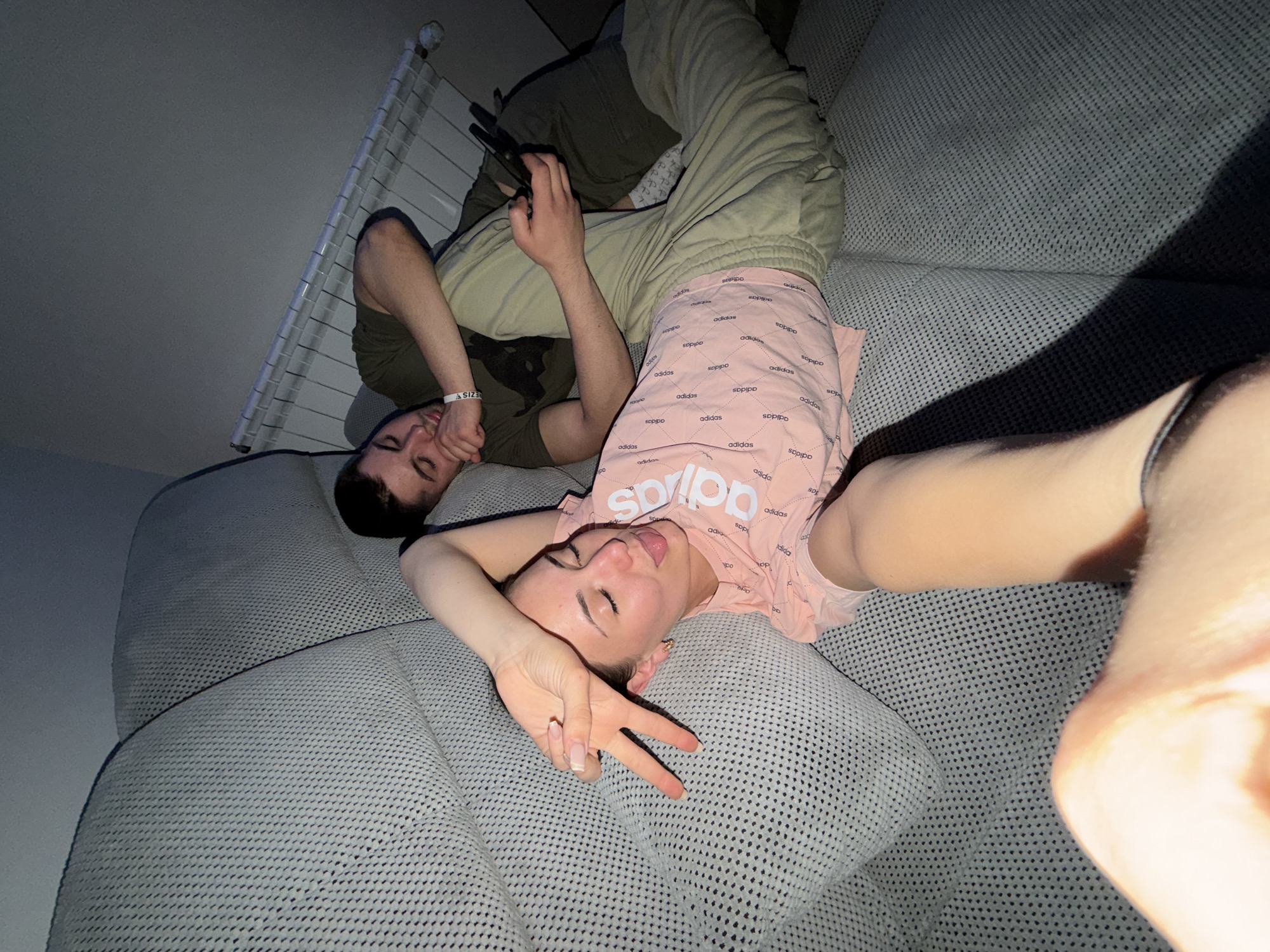 Two people relax on couch, play mobile games in Bulgaria
