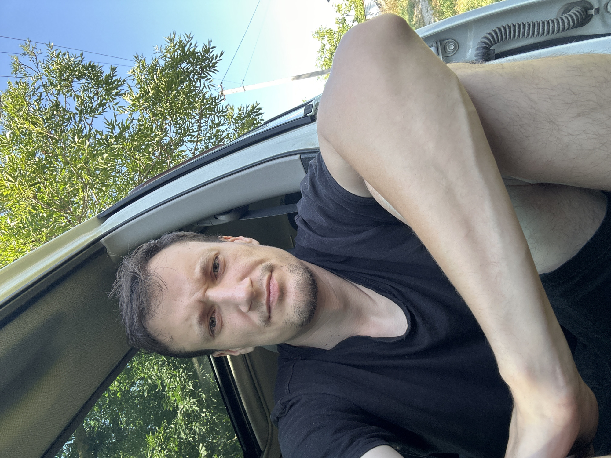 Parked Nissan, open door, selfies on a rural Ukrainian road