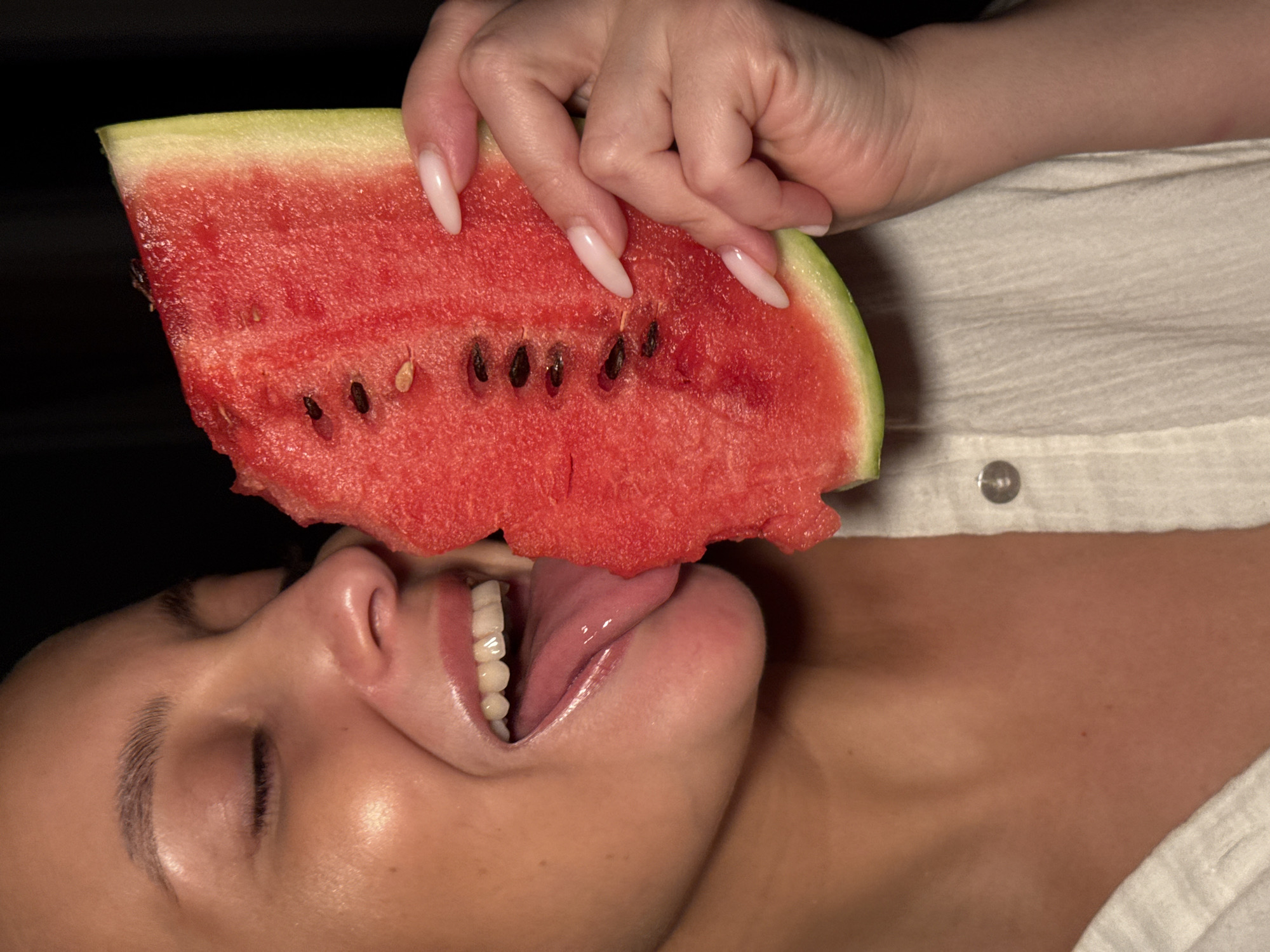 Person enjoys watermelon while resting in Chaikovsky, Russia