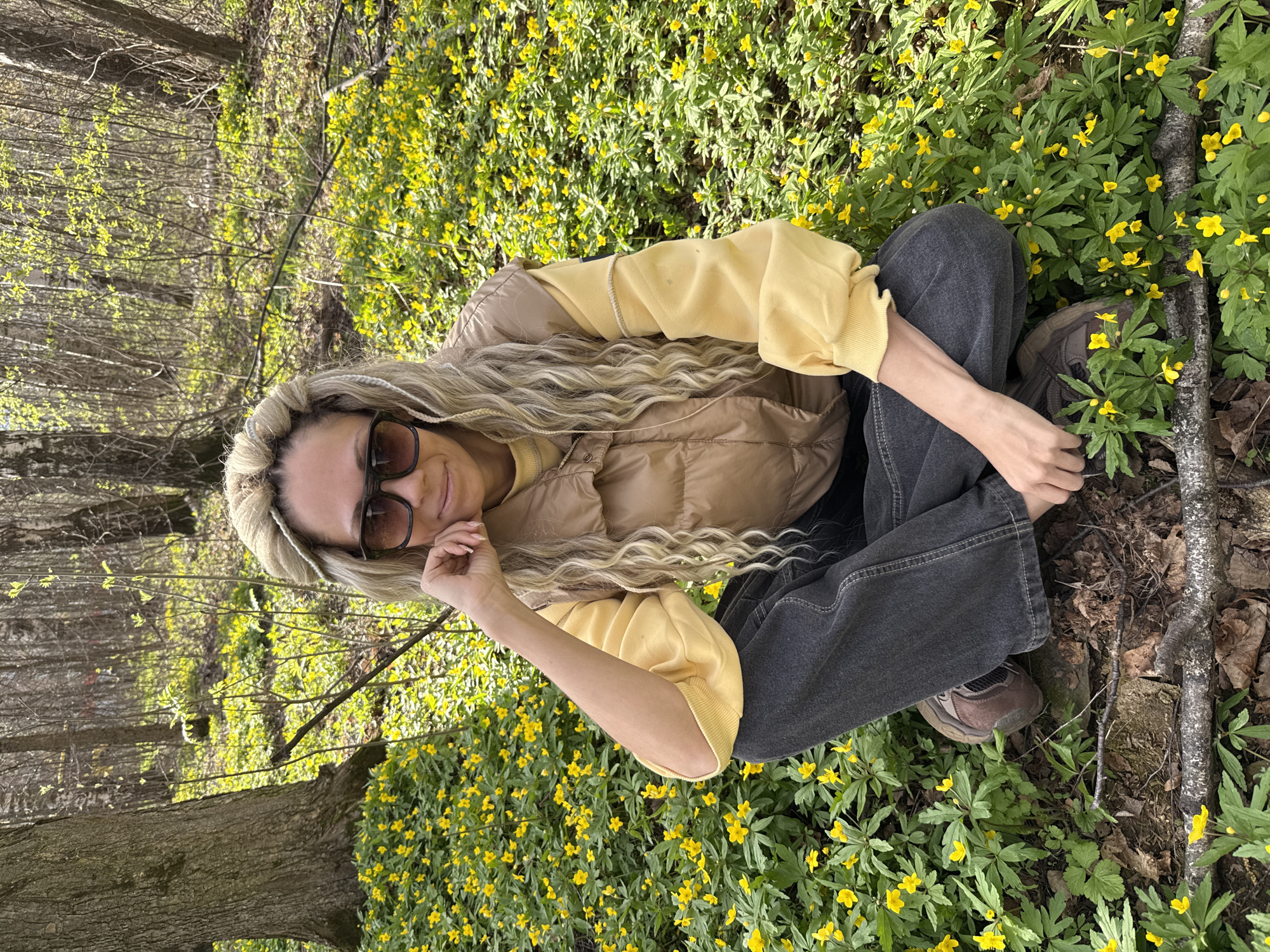 Woman poses with children among spring flowers in Rusanovo