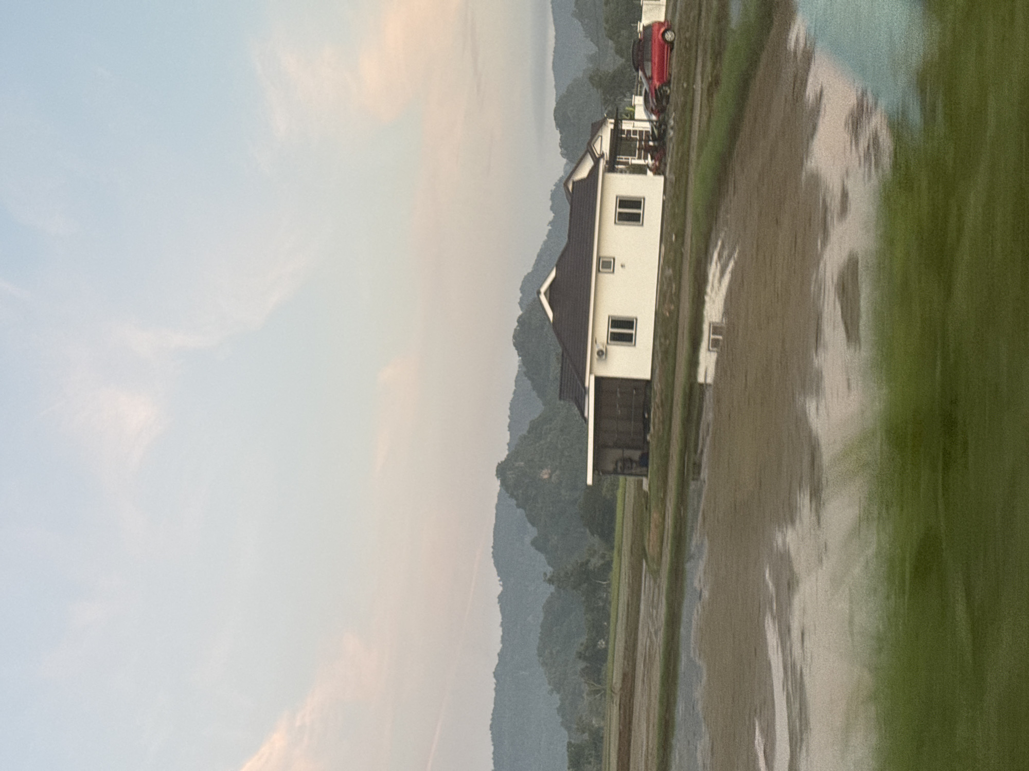 Flooded rice paddies and open road at dusk, Kangar