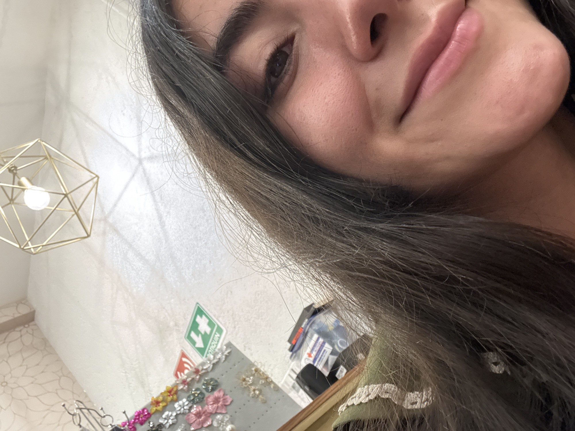 Woman takes selfies while shopping in Domingo Arenas boutique