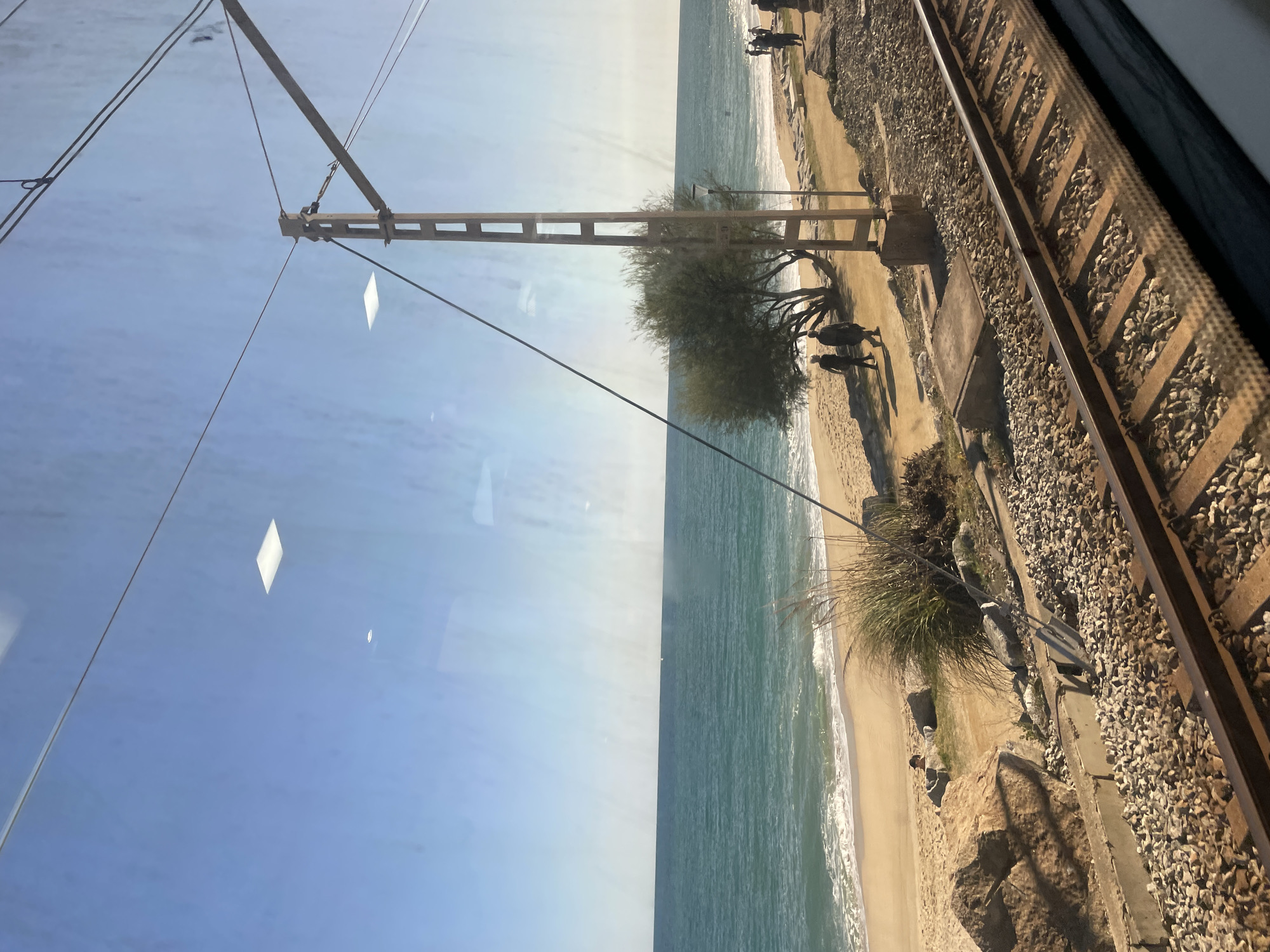 Train passenger views Mediterranean coast near Sant Andreu de Llavaneres