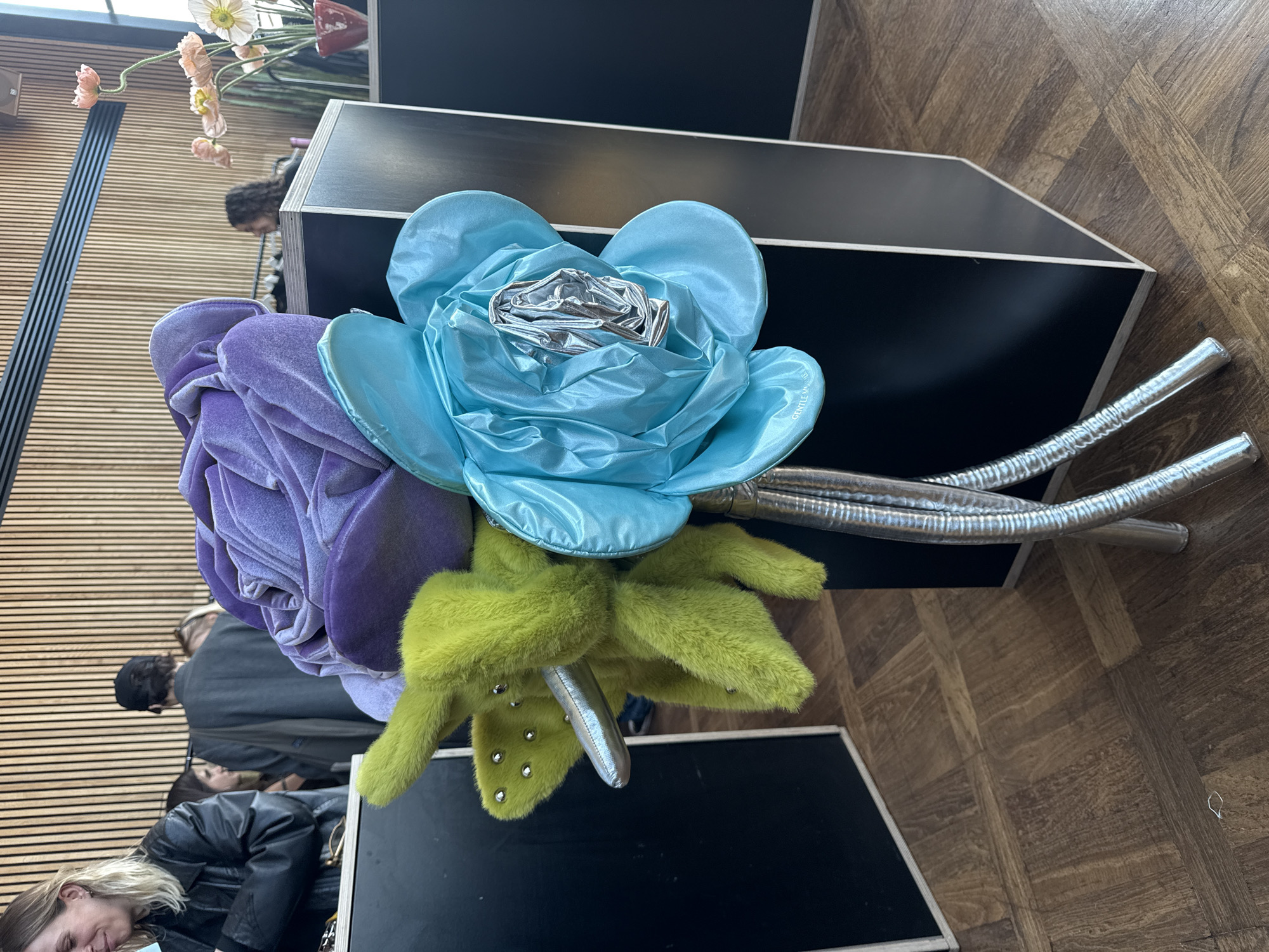 Person in Mickey Mouse helmet observed with fabric flowers