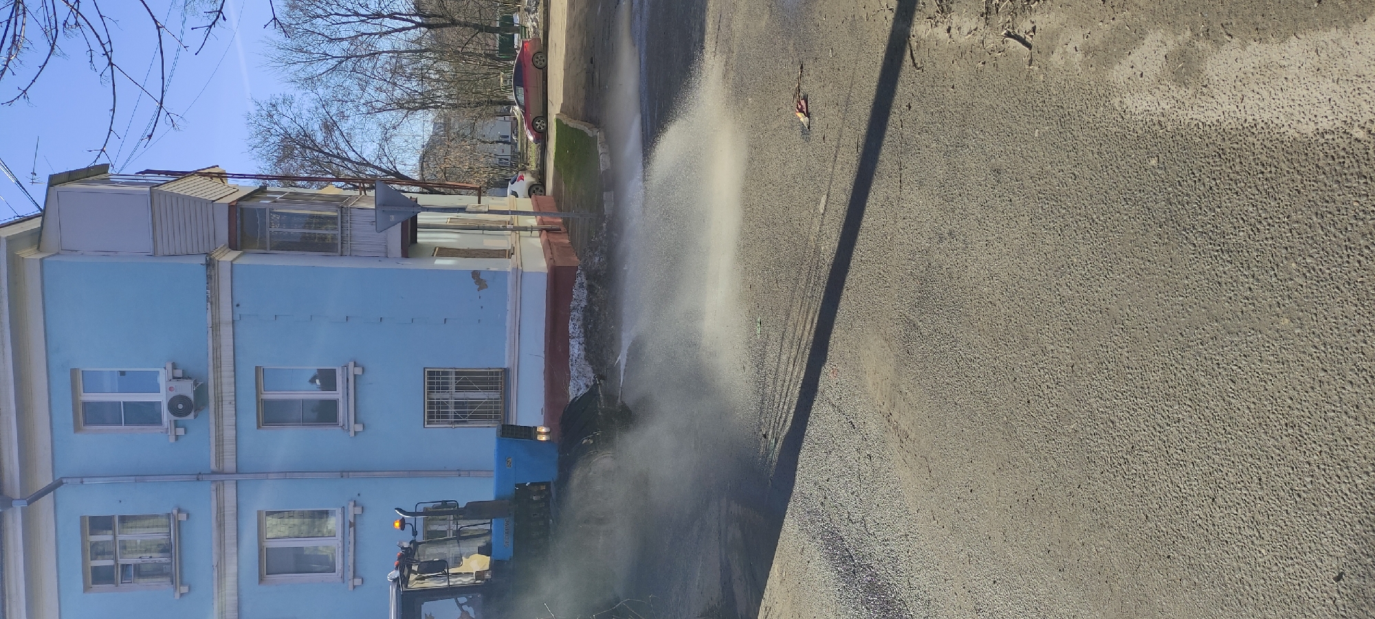 Morning street cleaning and resident activity in Fryazino, Russia