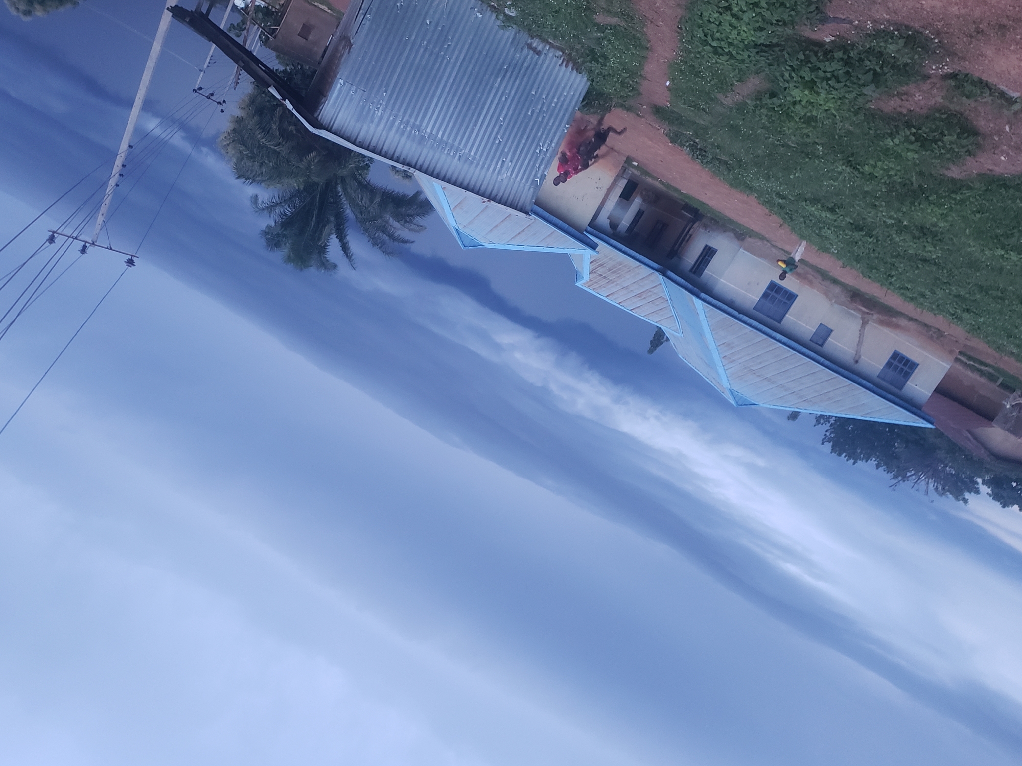 Storm clouds gather over weathered building, witness documents conditions
