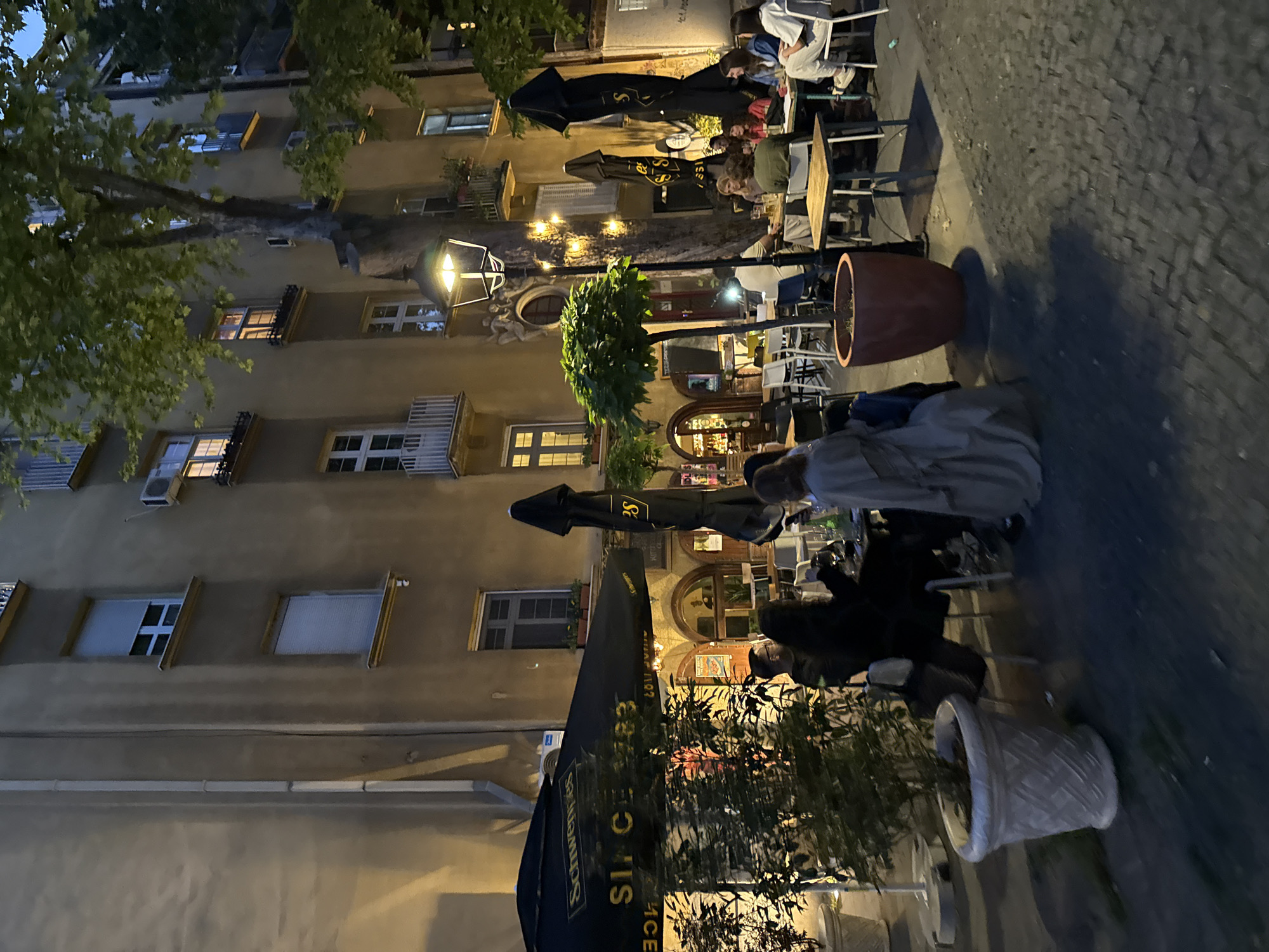 Evening street life captured in Belgrade's cobblestone district