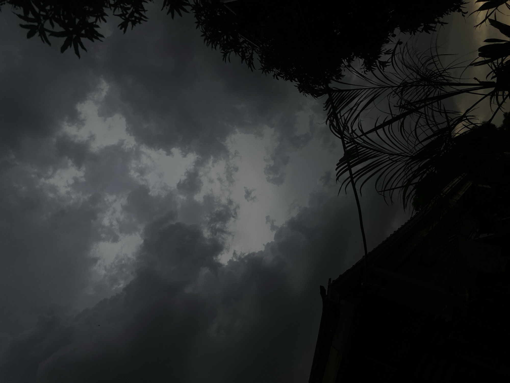 Storm clouds gather over Nigerian residential area, child plays