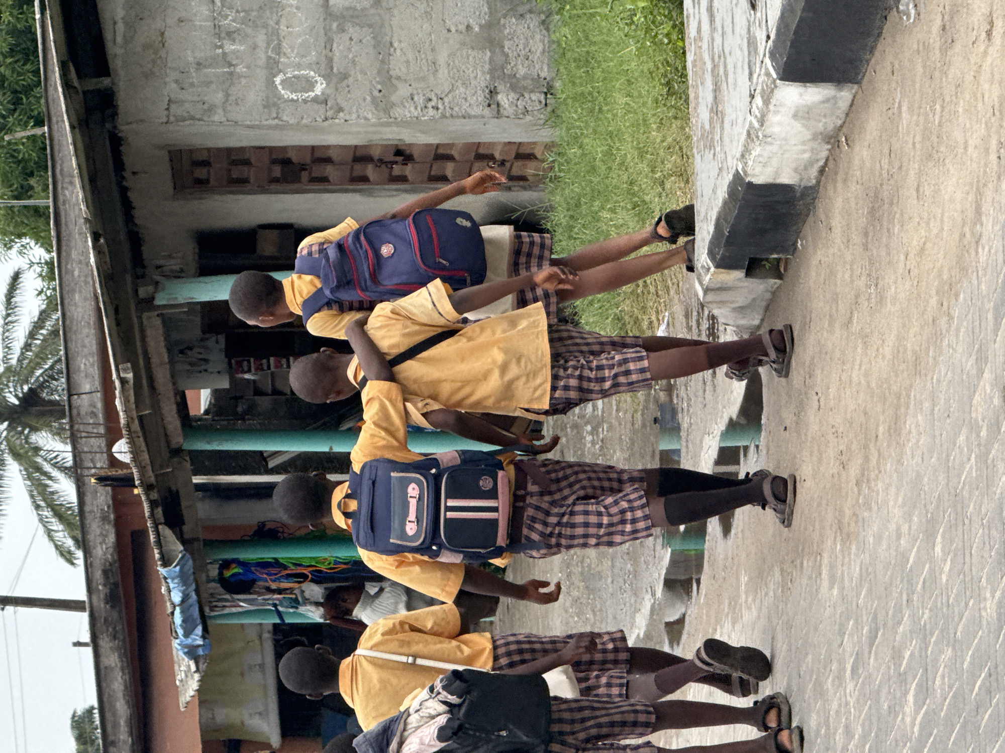 School children walk through Badagry streets during midday hours