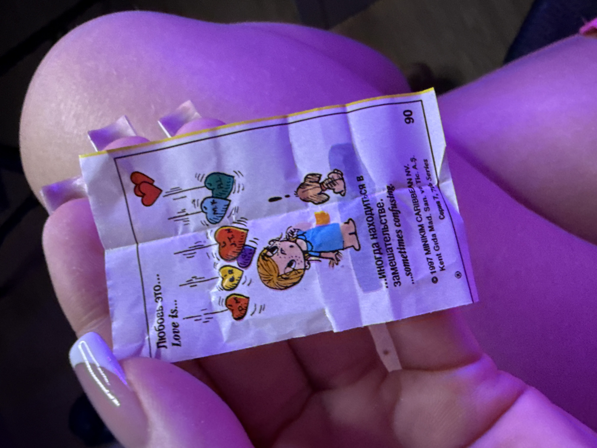 Person holds illustrated paper with hearts in Batumi