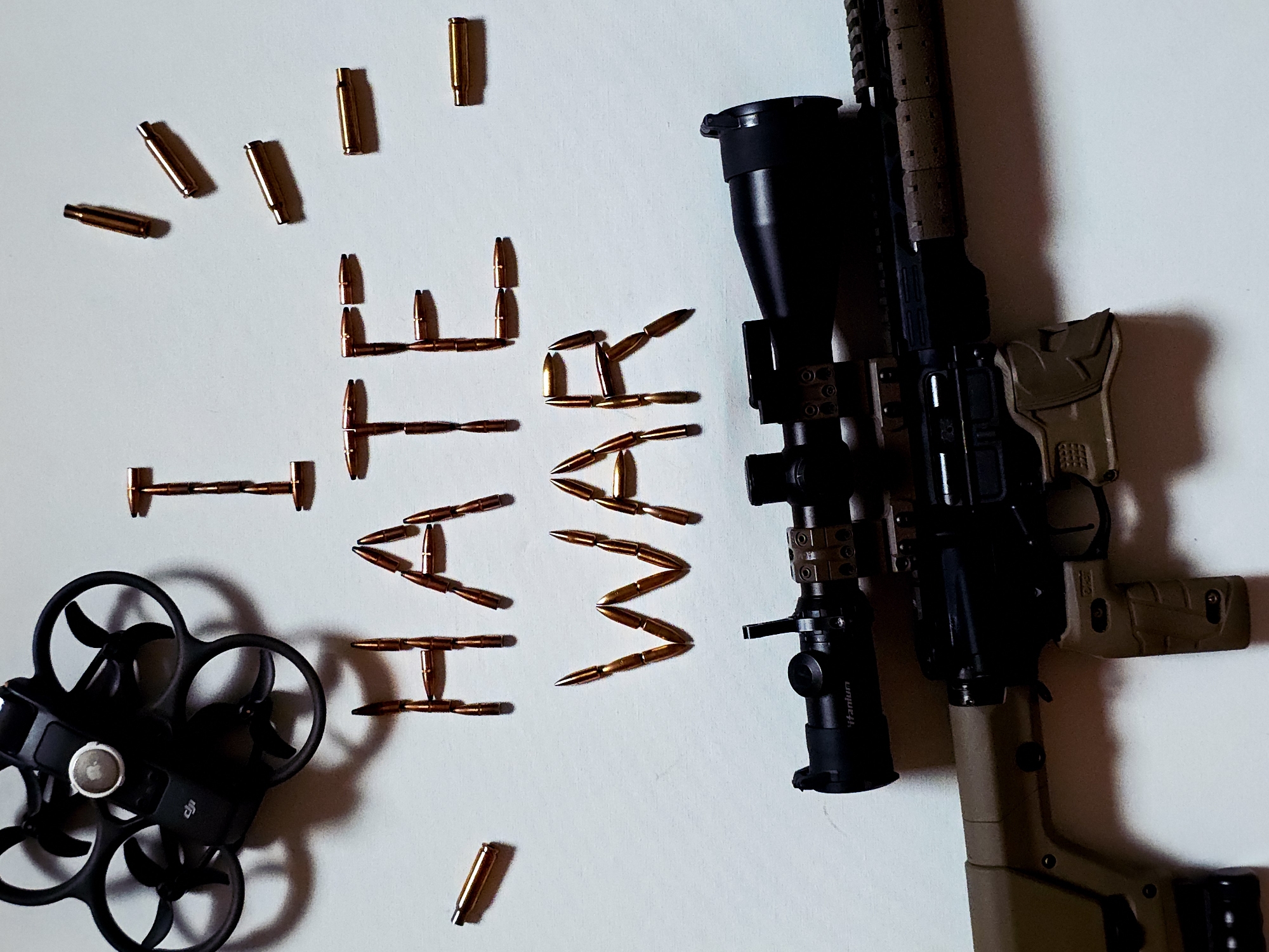 Anonymous photographer stages anti-war messages using firearms and ammunition