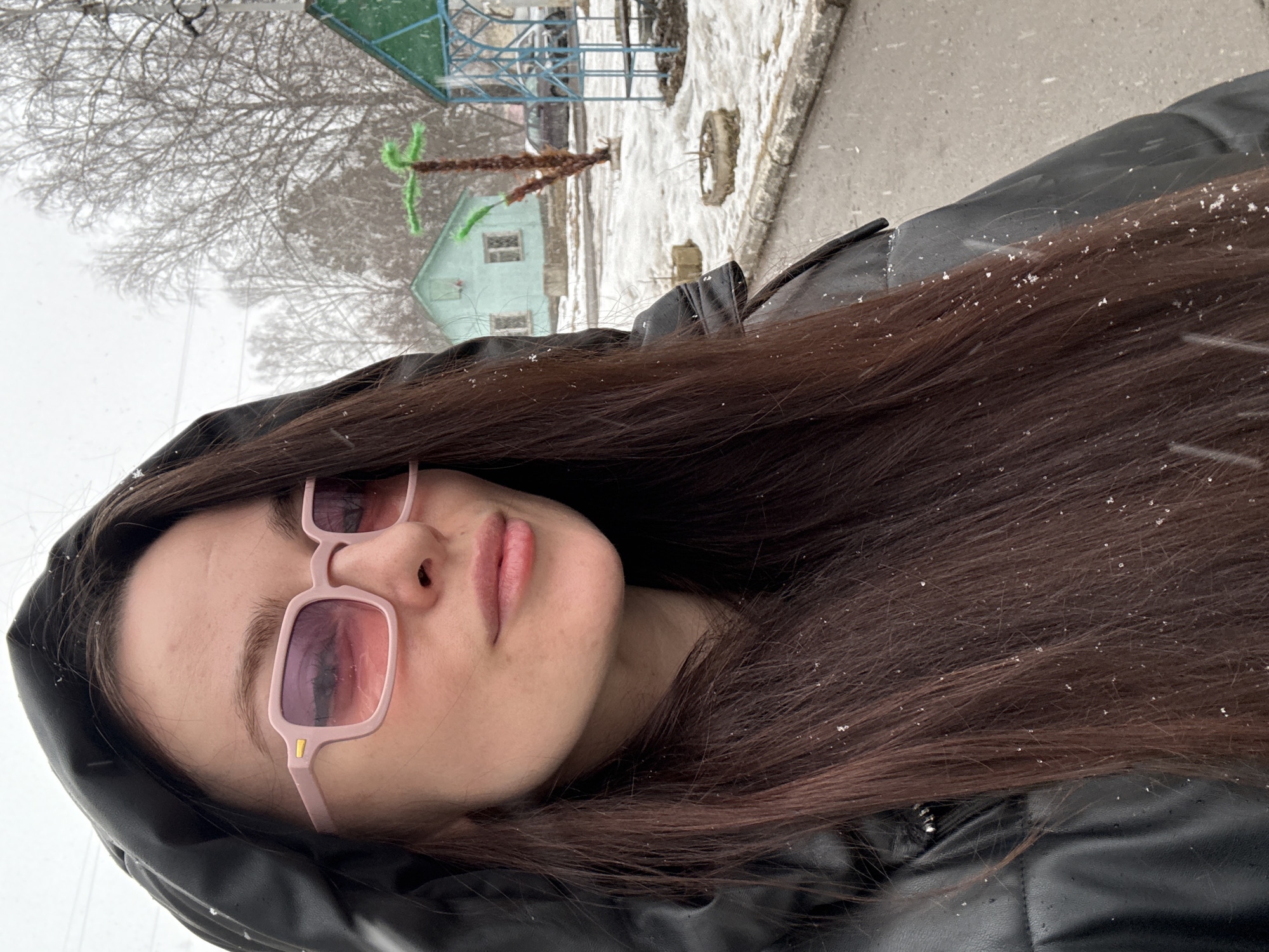 Woman photographed in spring snowfall in Kedrovy, Russia