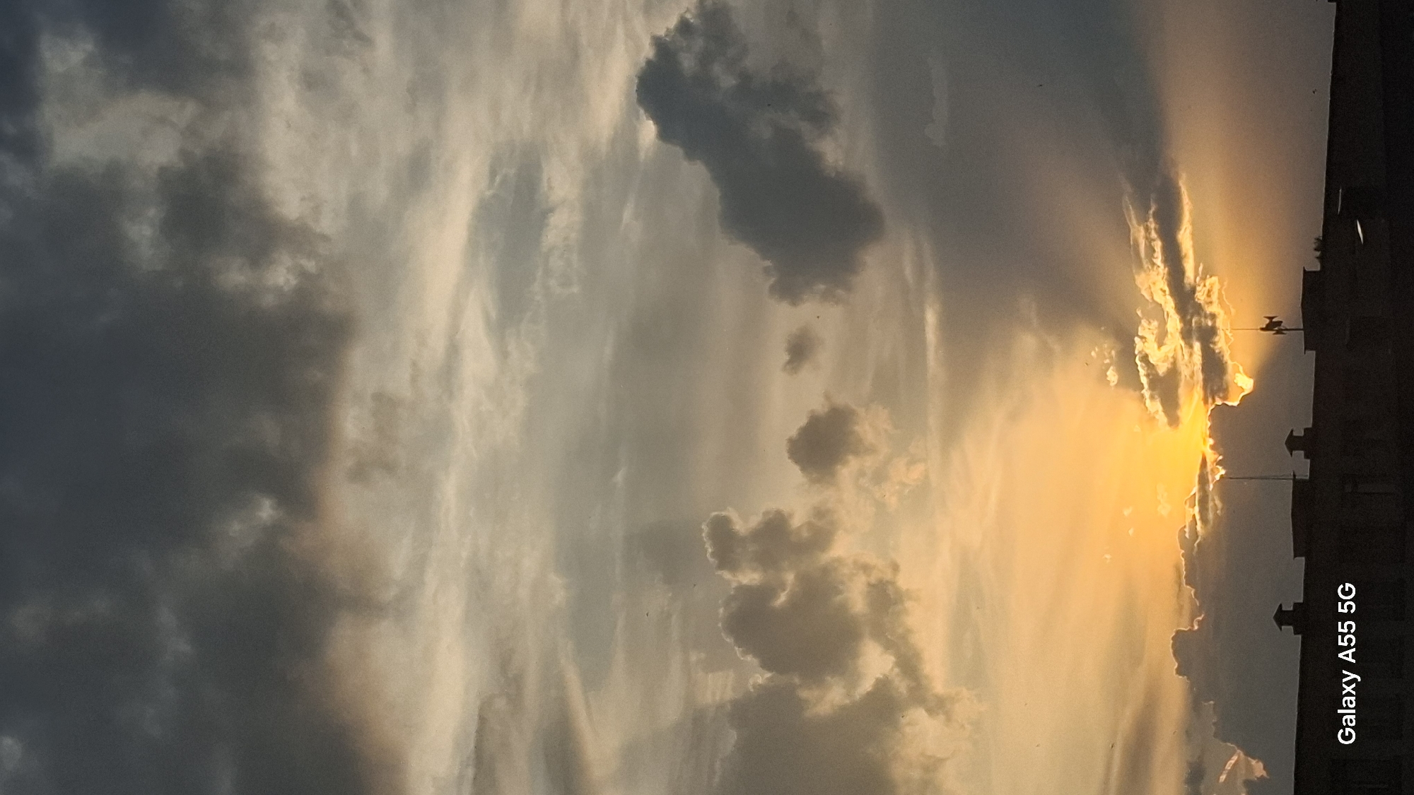 Golden sunset breaks through storm clouds over Tolyatti rooftops
