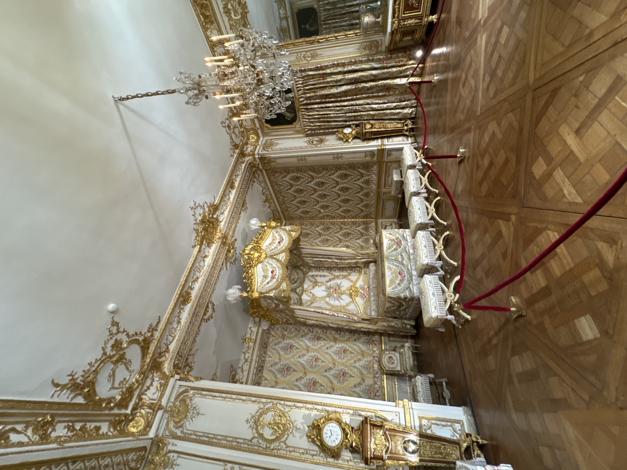 Tourists tour ornate halls and artwork at Palace of Versailles