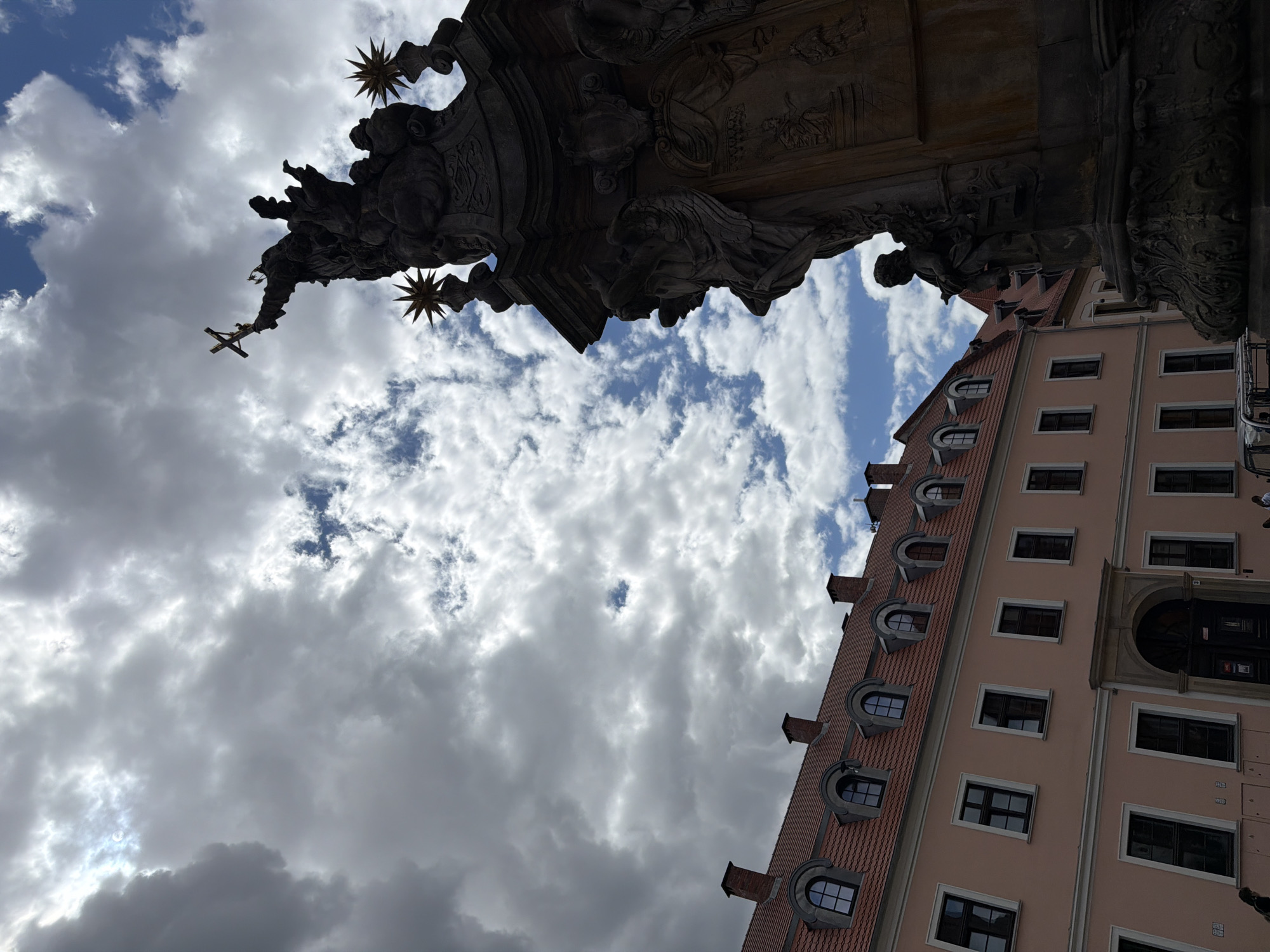 Gothic spires, stone statues, and cobblestone courtyards in a historic city center