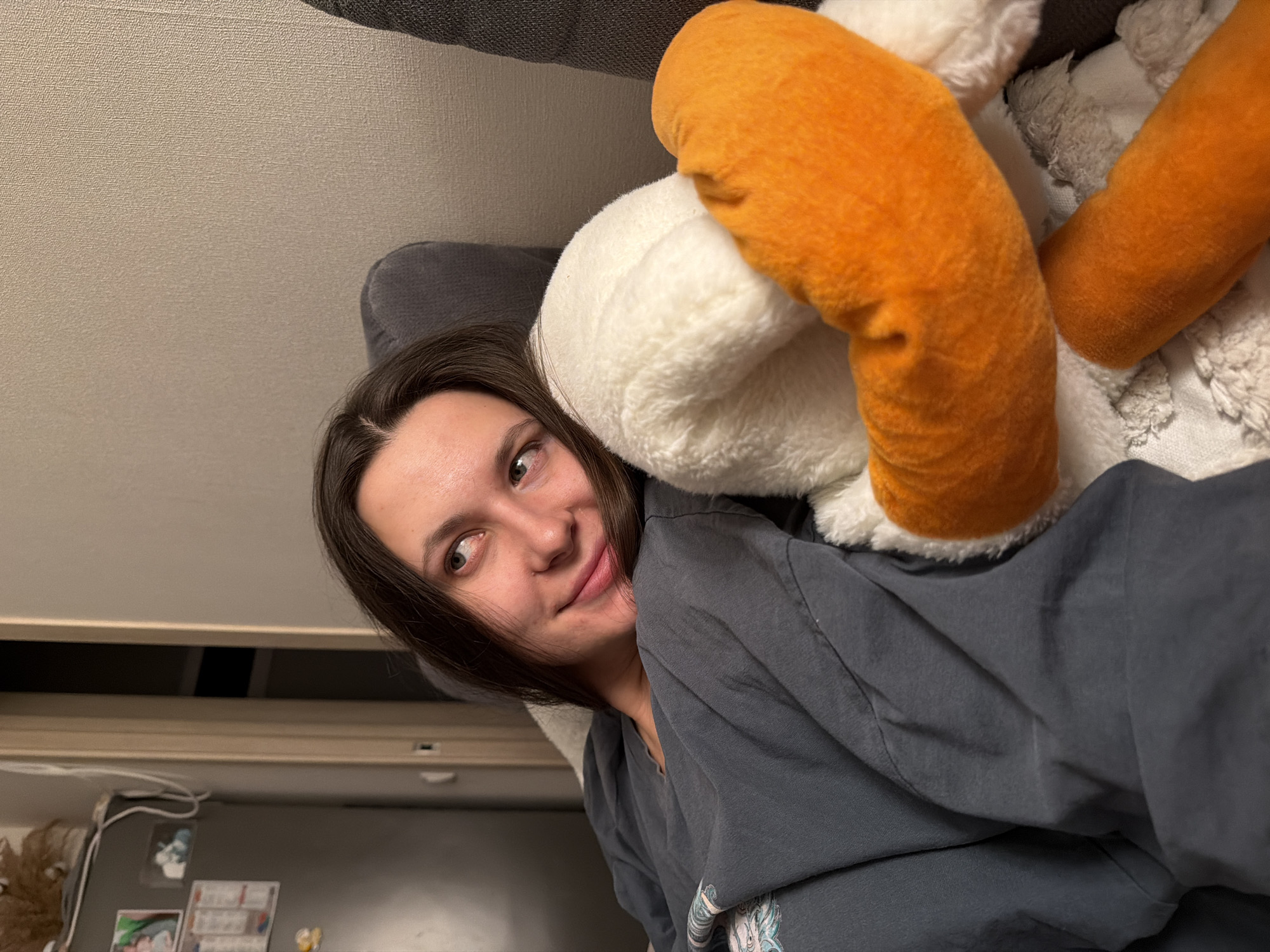Woman rests with plush toy on sofa in Odintsovo