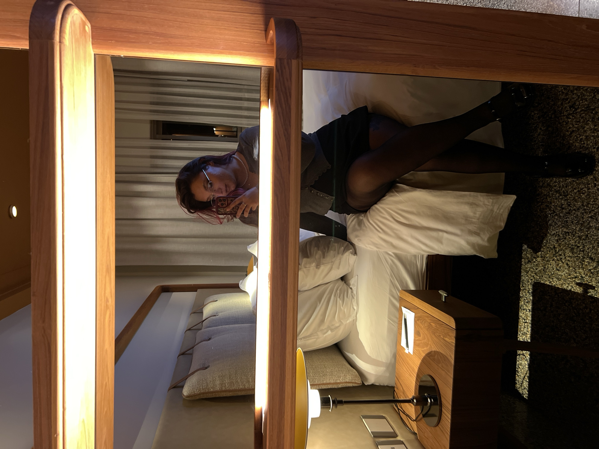 Young woman documents evening with selfies in Tel Aviv accommodation