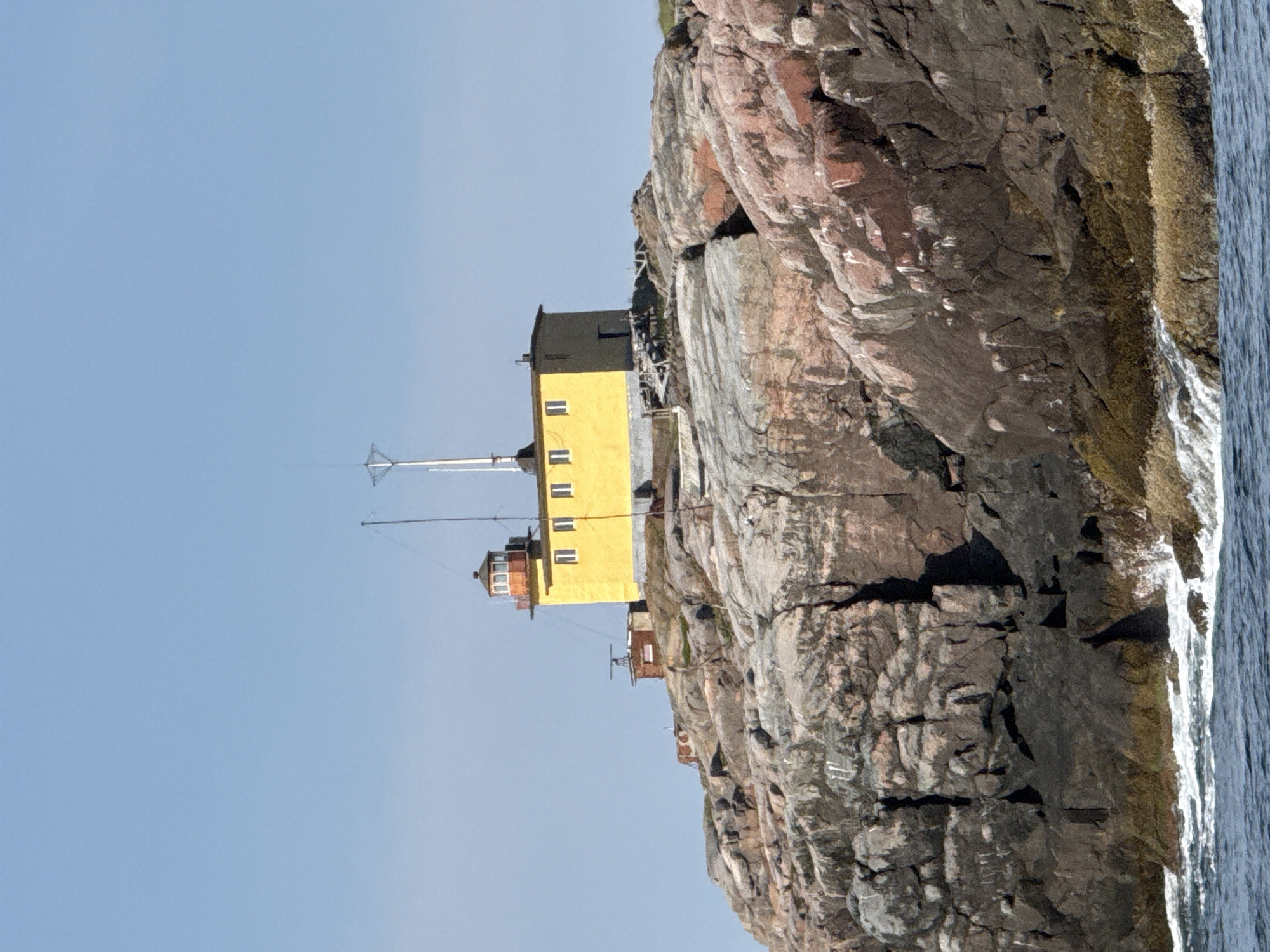 Yellow lighthouse on rocky Barents Sea coast, Teriberka