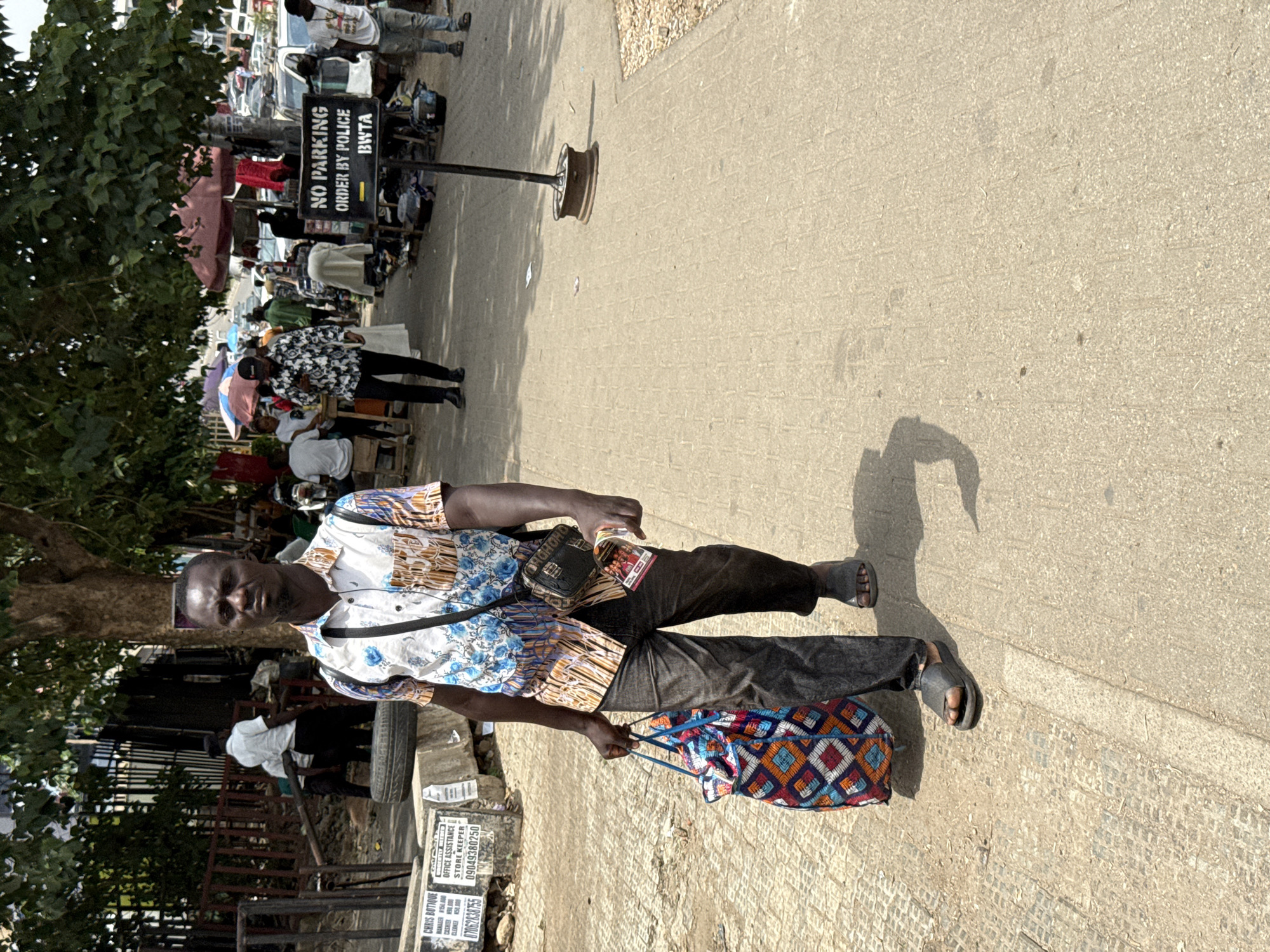 Ordinary life documented across Abuja's commercial districts during midday