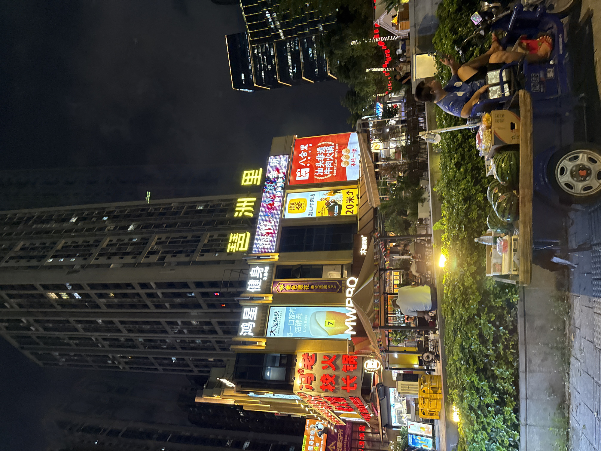 Haizhu District streets alive at midnight, neon and traffic