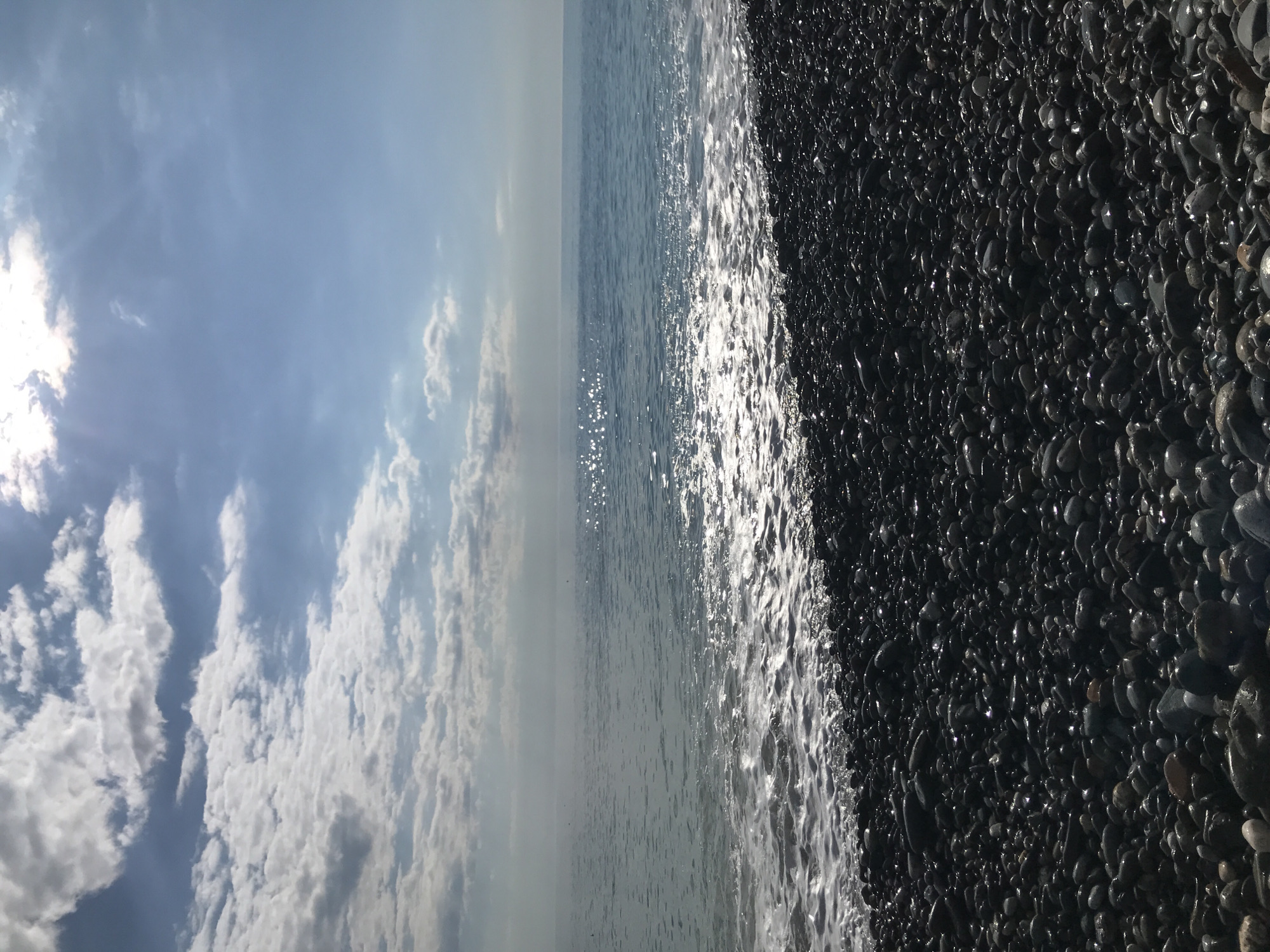 Sunny day at Black Sea pebble beach in Sochi