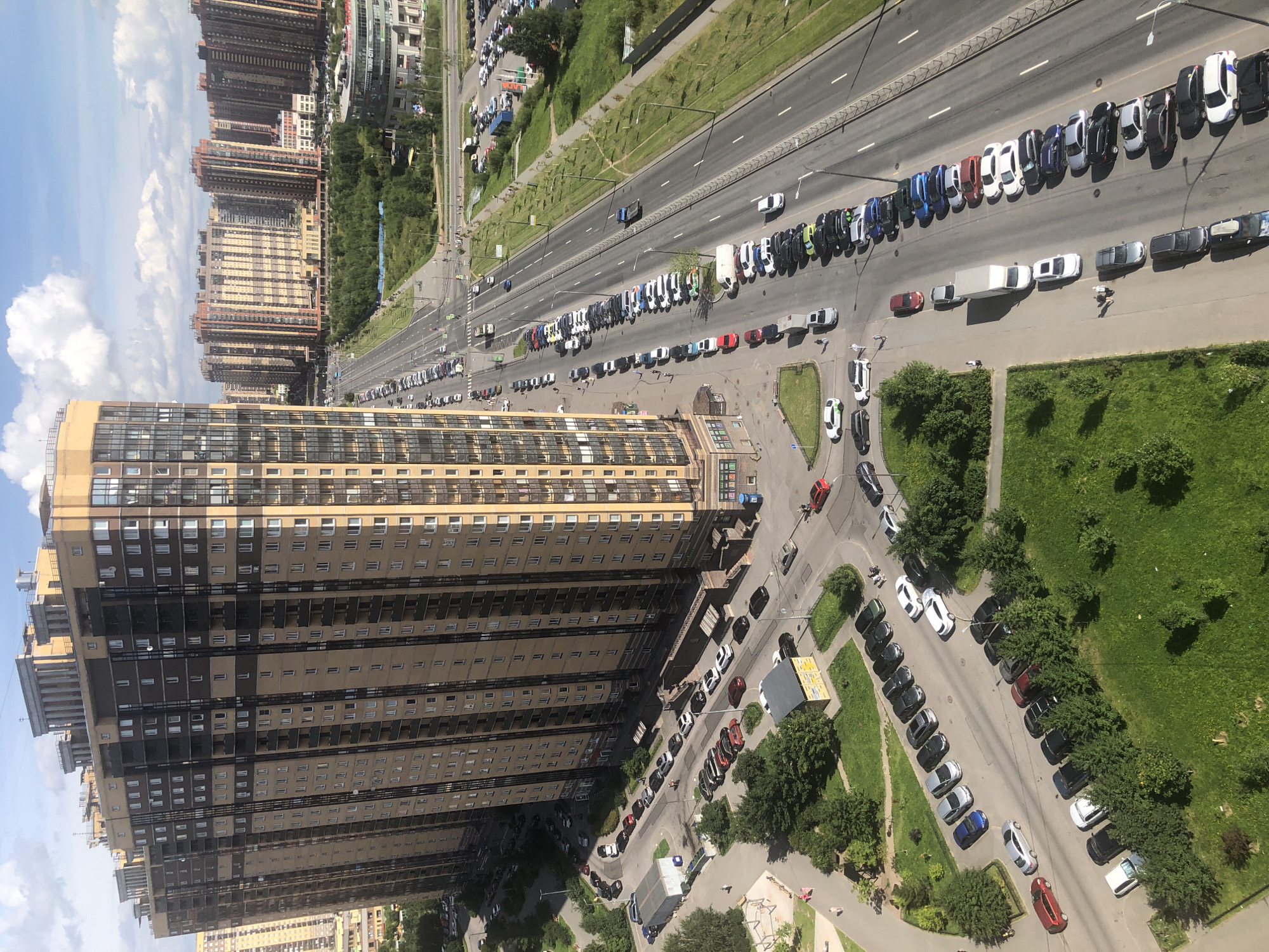 Aerial sweep of a dense residential district with a LADA dealership