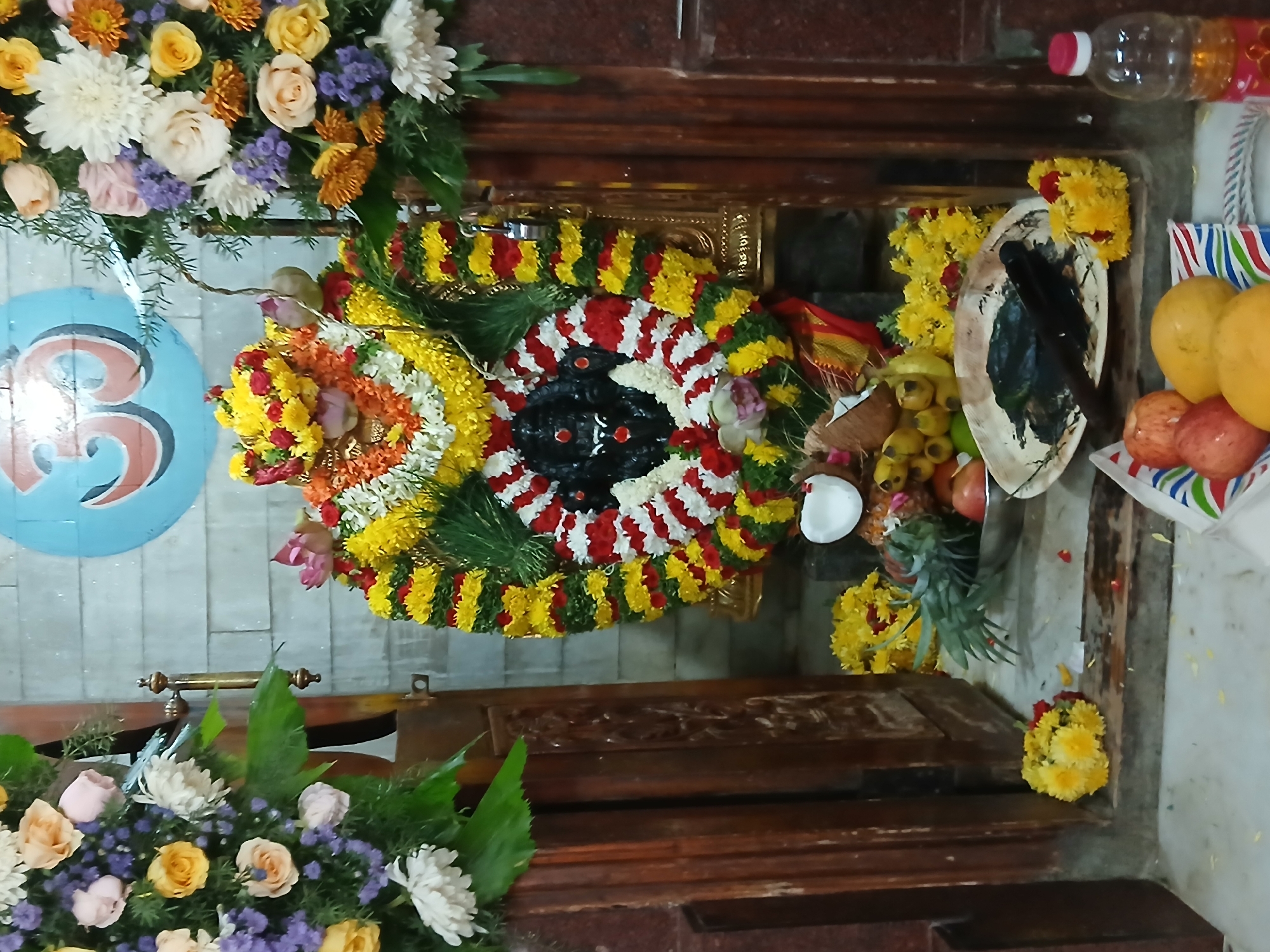 Hindu shrine with flower garlands observed in Bengaluru