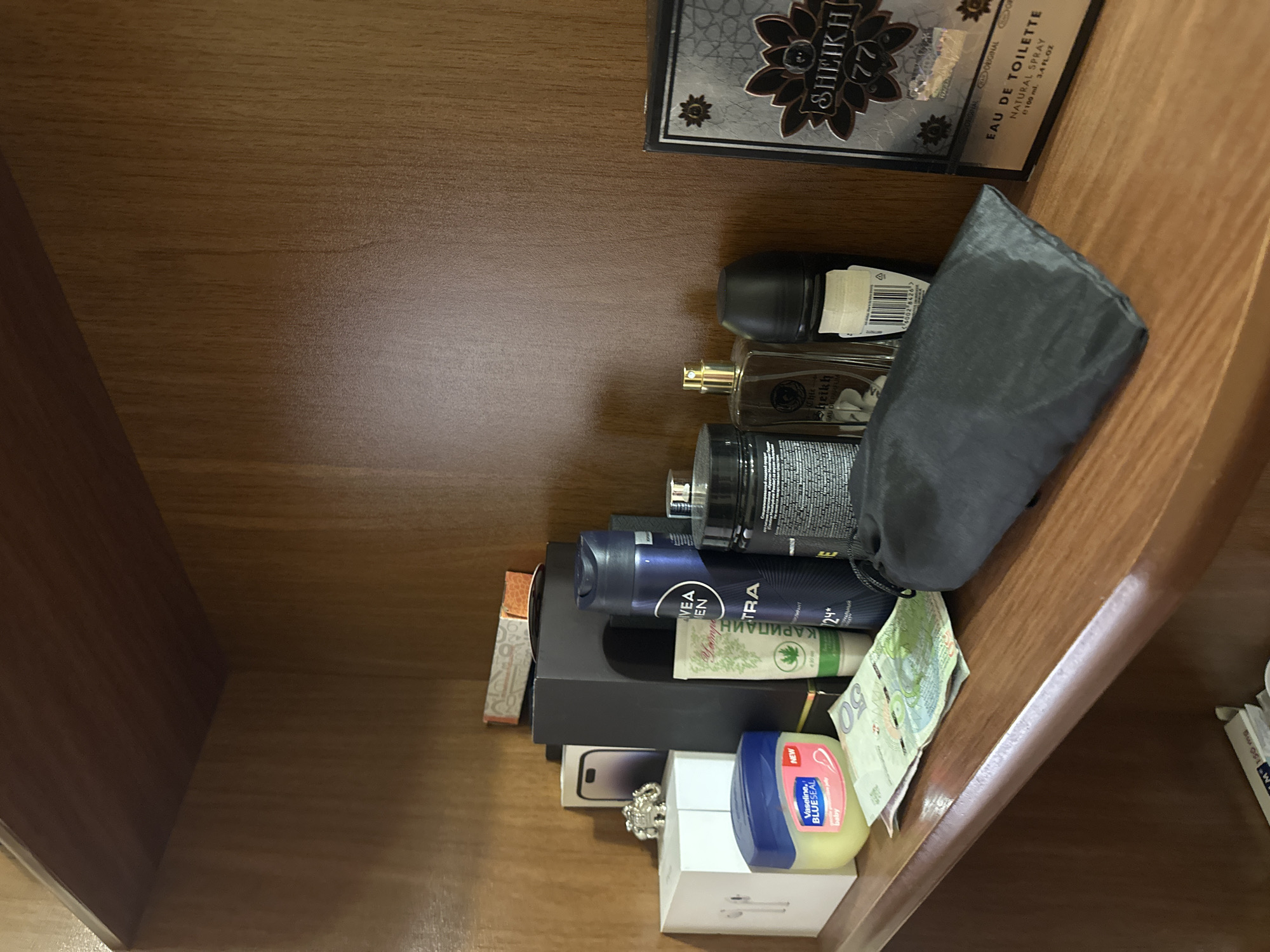 Personal items documented on shelves and wooden surface