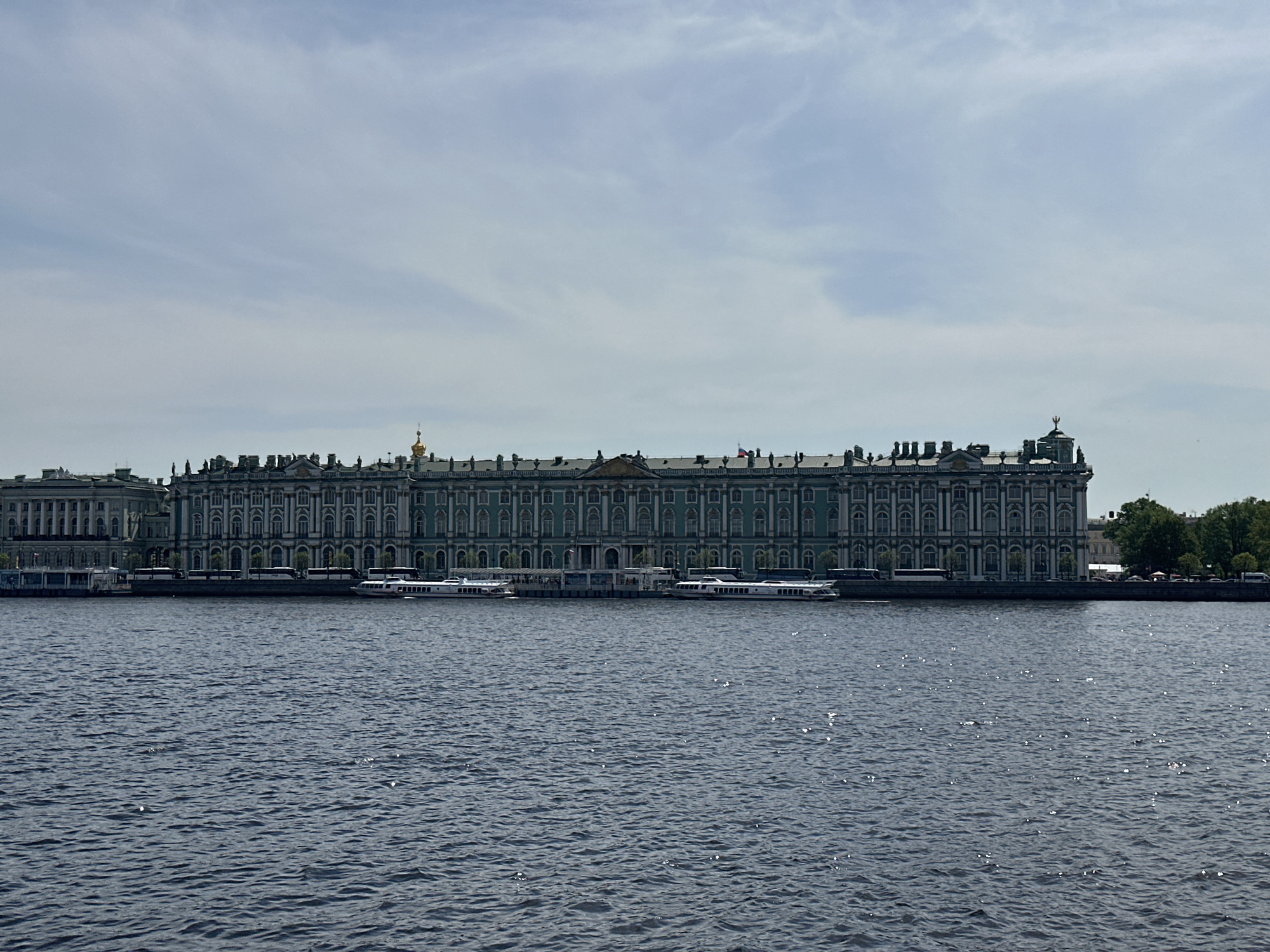 Tourist visits Winter Palace embankment in Saint Petersburg
