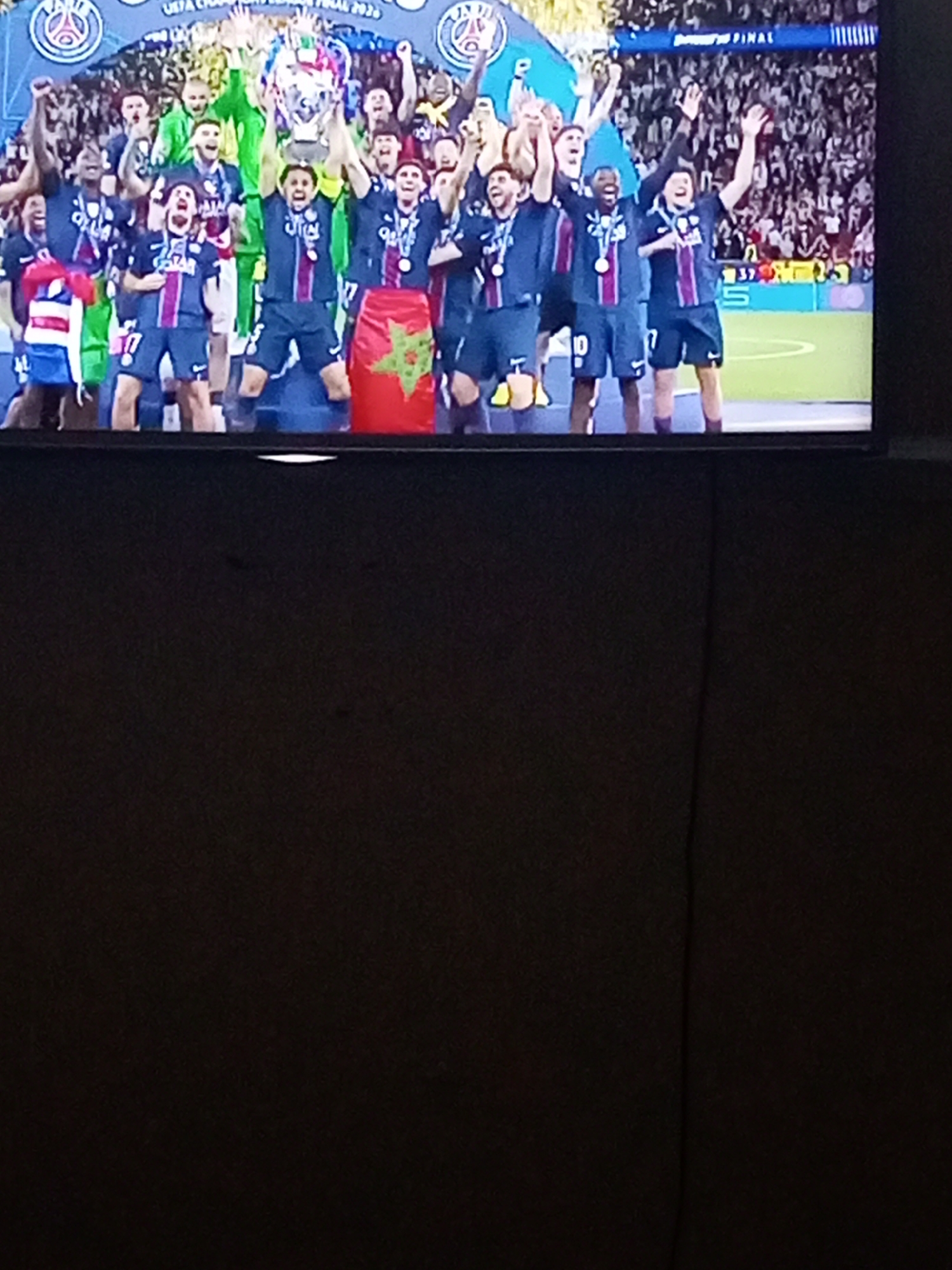 Soccer team celebrates trophy victory with Moroccan flag on TV