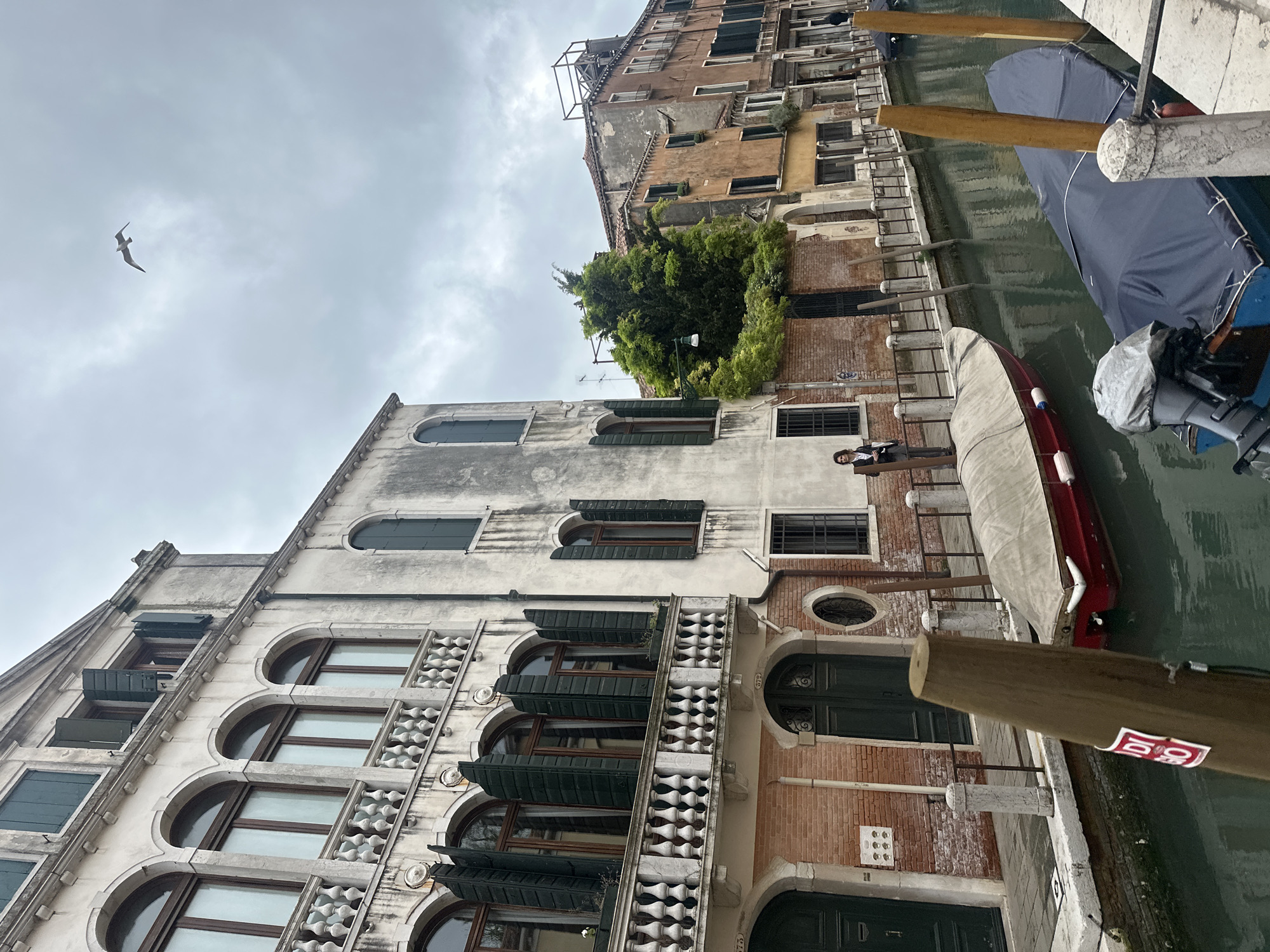 Venice canal scene captured with person on balcony
