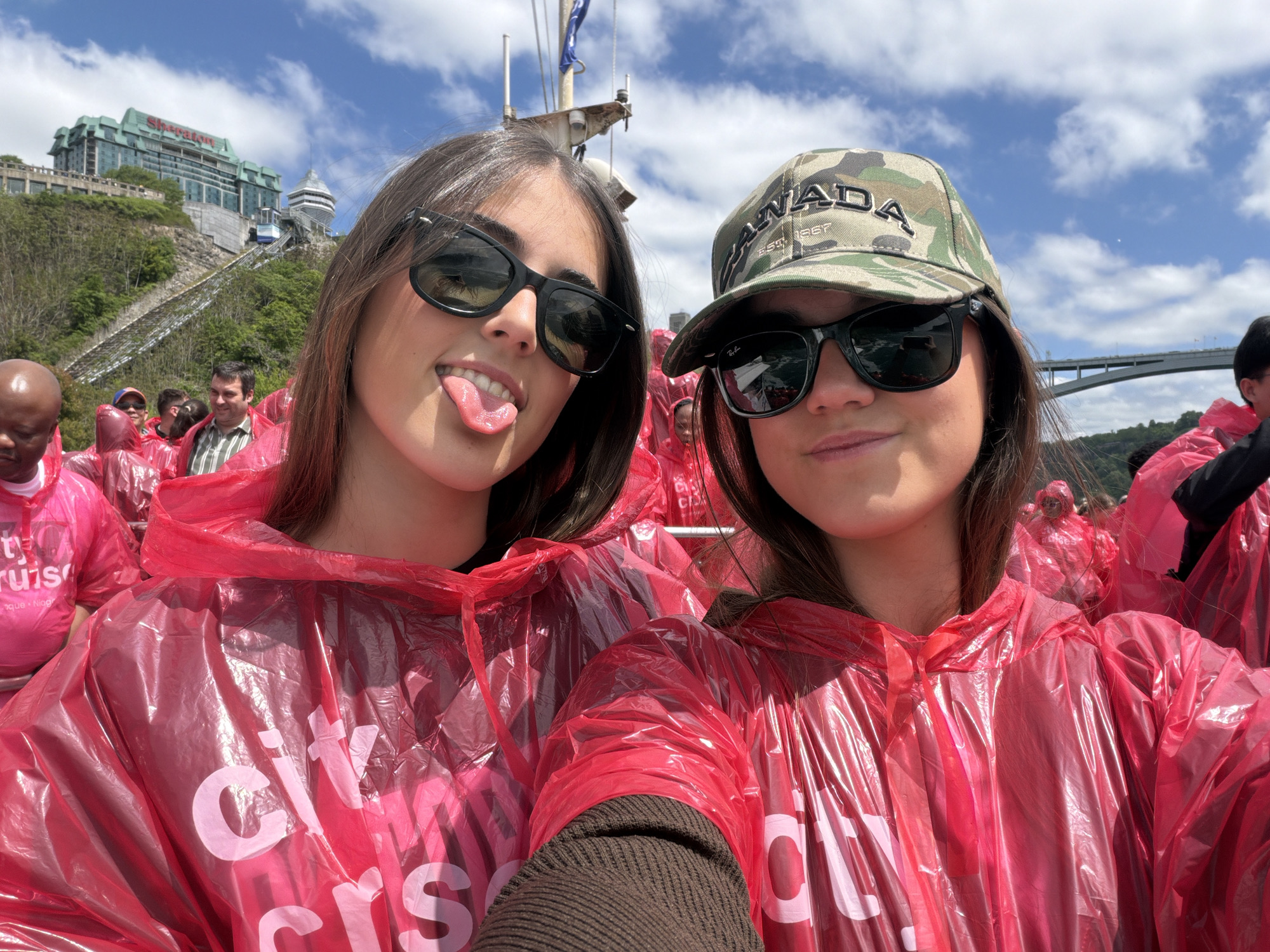 Tourists document Niagara Falls boat tour experience from Canadian side