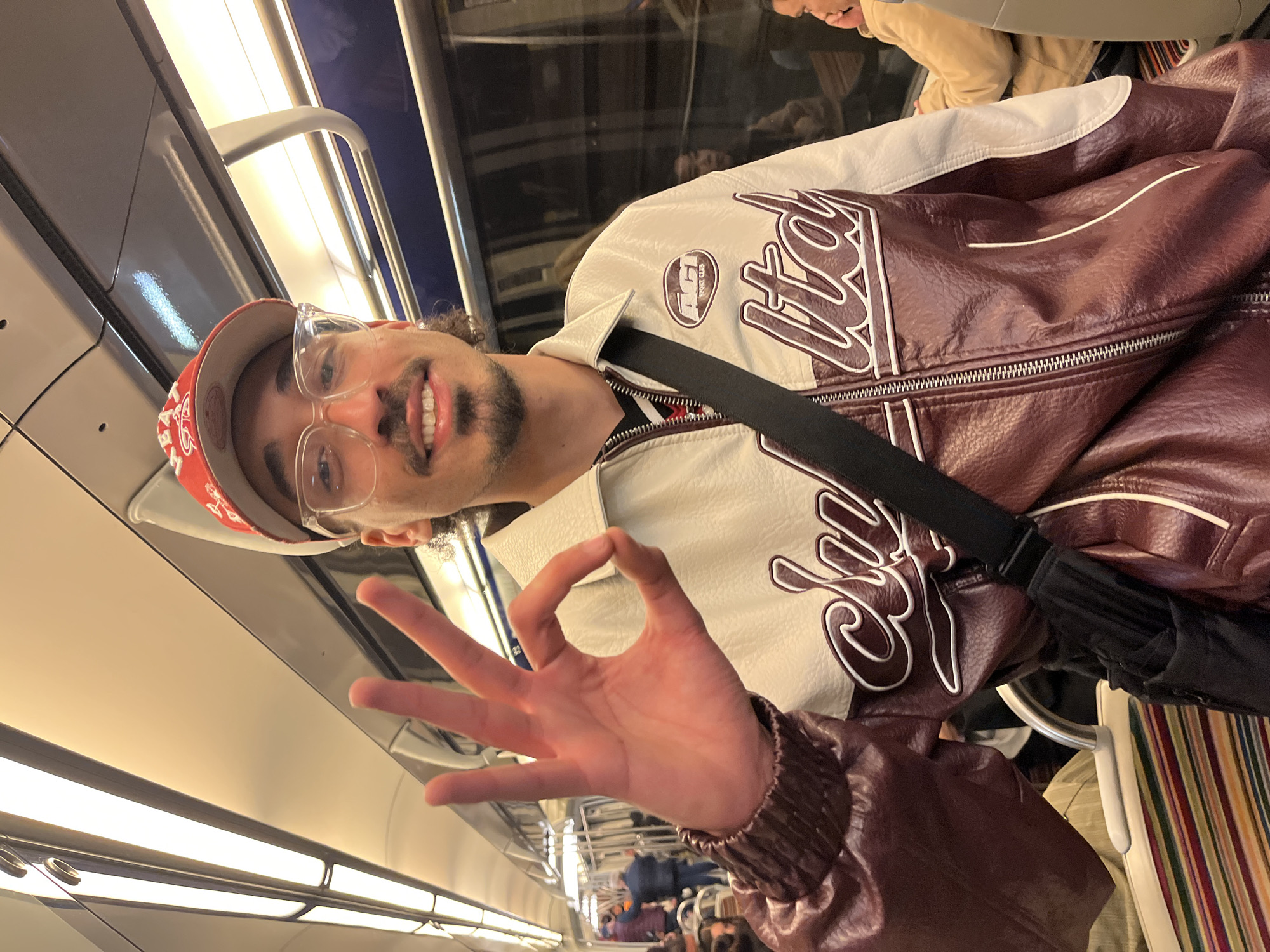 Man gestures on Paris Metro as tropical drink spotted nearby