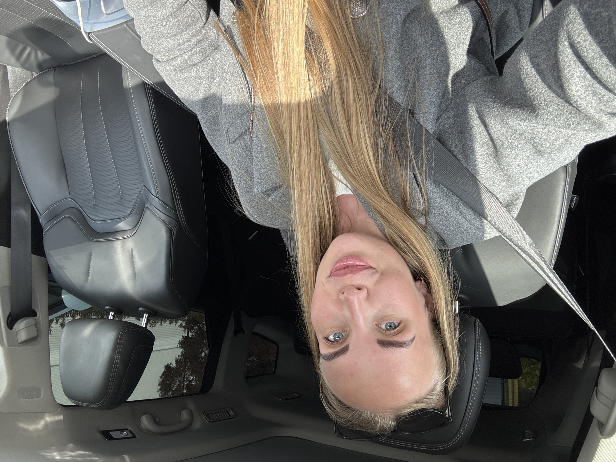 Woman takes selfies in car driver's seat in Sirius