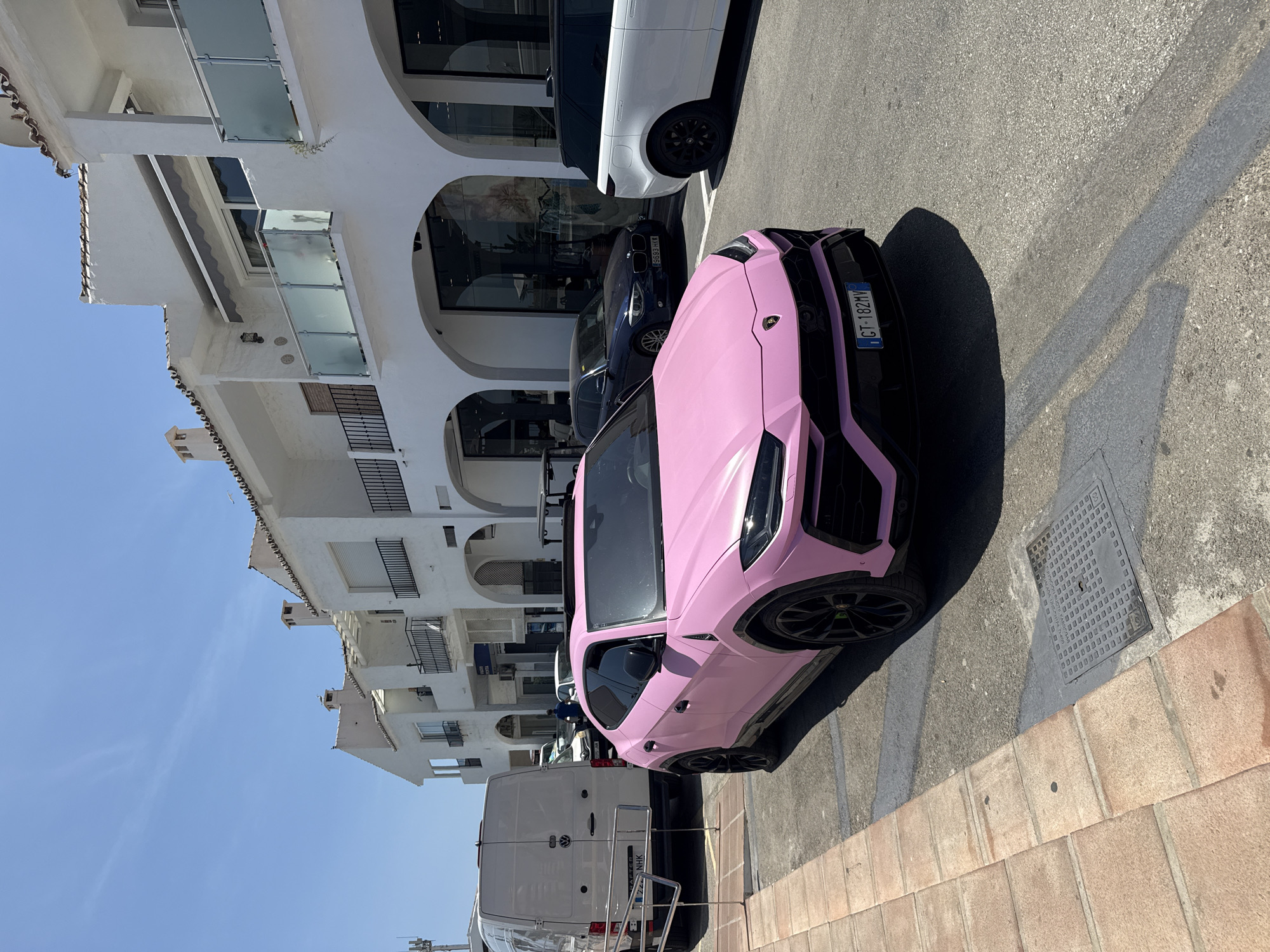 Pink Lamborghini Urus parked in sunny Marbella