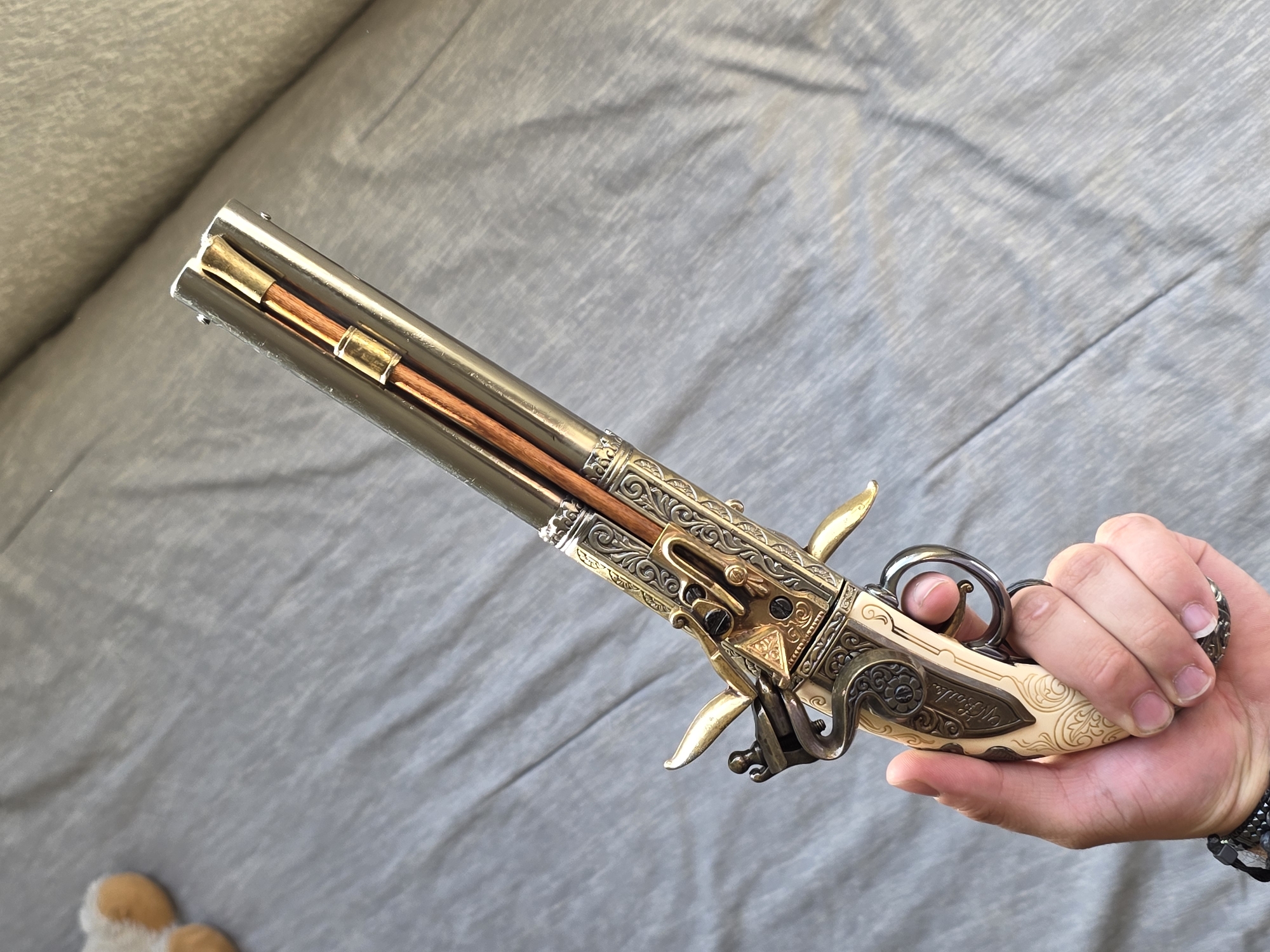 Person displays ornate antique pistol in Puebla, Mexico