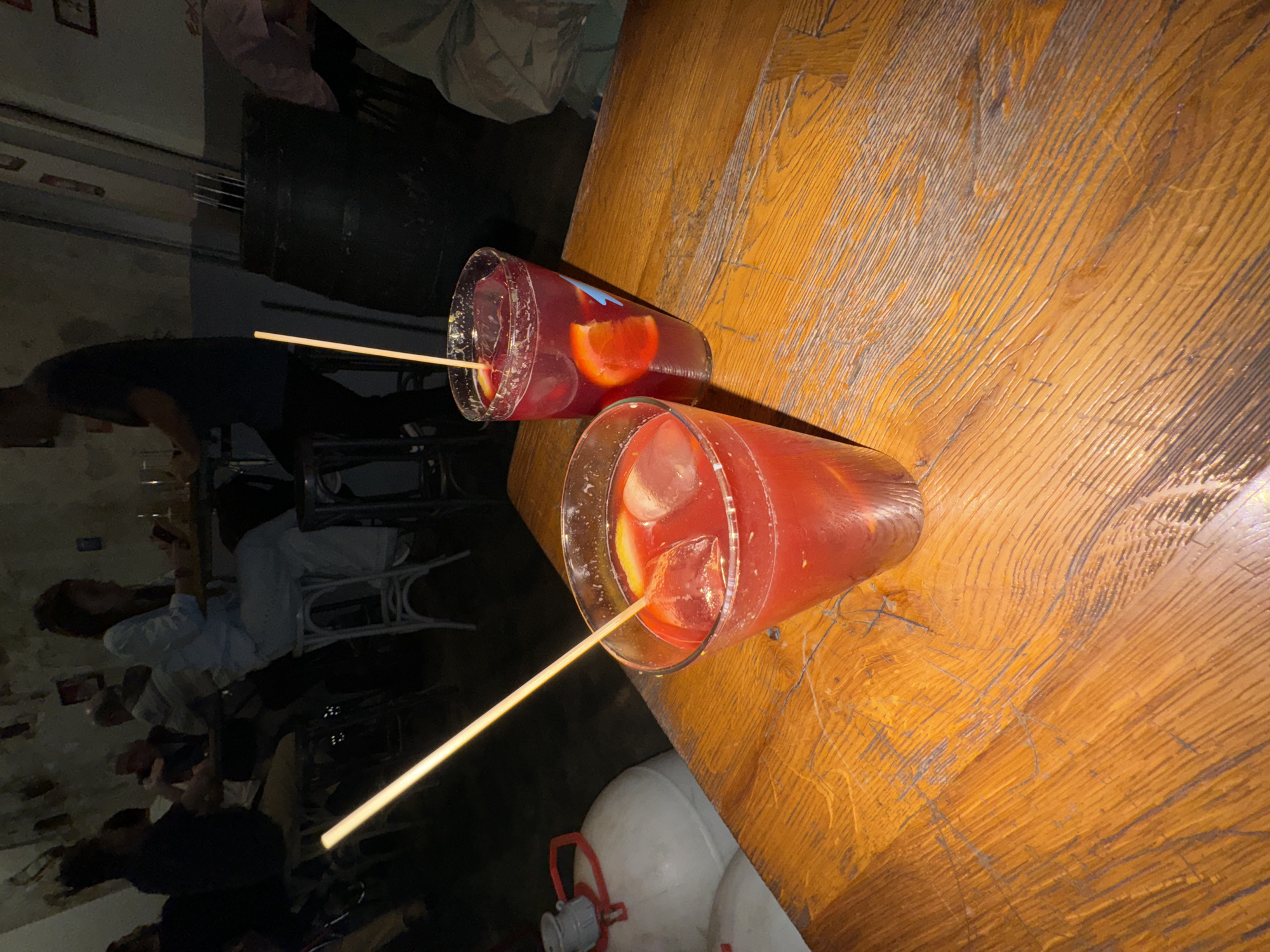 Red cocktails served on wooden table in Barcelona